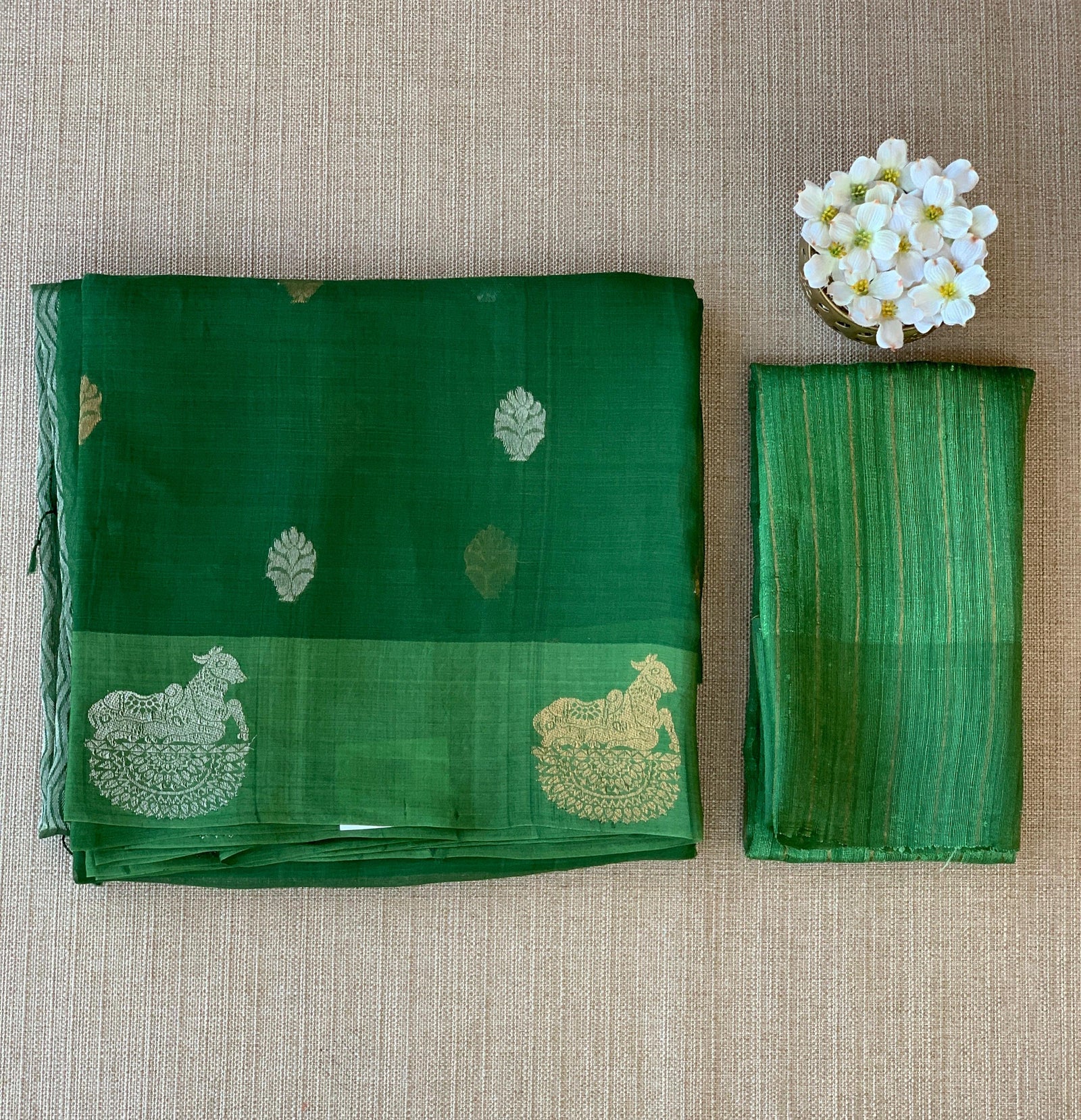 Emerald Green kora muslin sarees with kaduwa woven nandi motif border