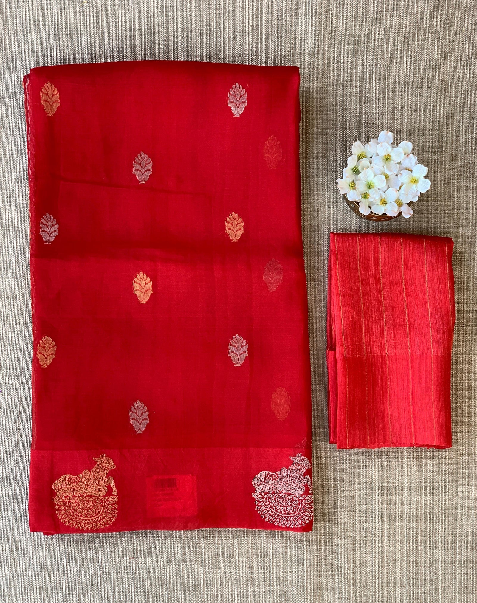 Red kora muslin sarees with kaduwa woven nandi motif border