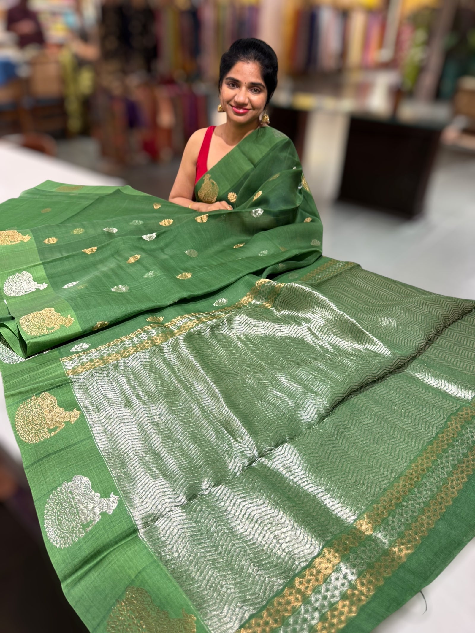 Emerald Green kora muslin sarees with kaduwa woven nandi motif border