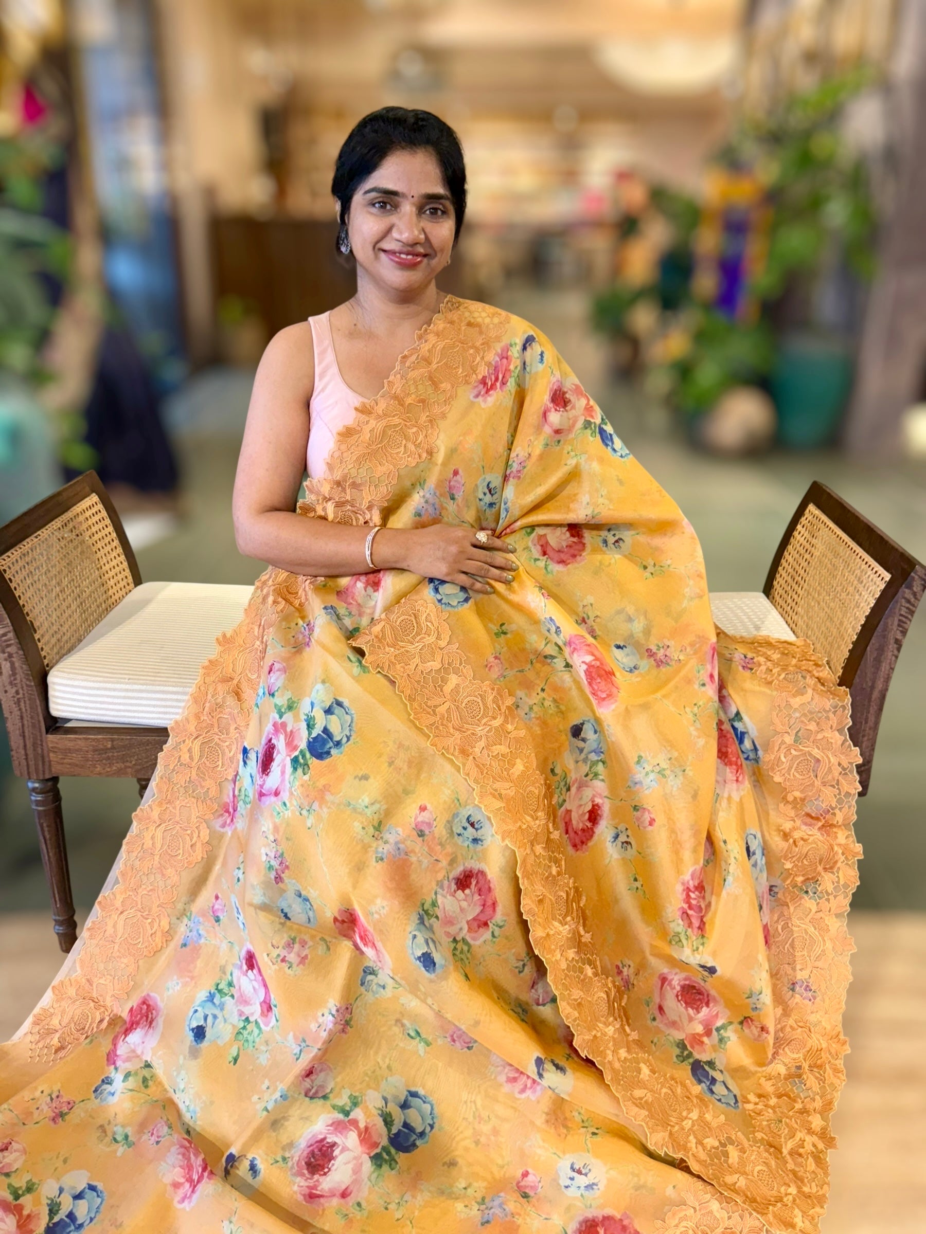 Mustardish Orange Printed Organza Saree With Chantilly Lace Style Embroidered Border.
