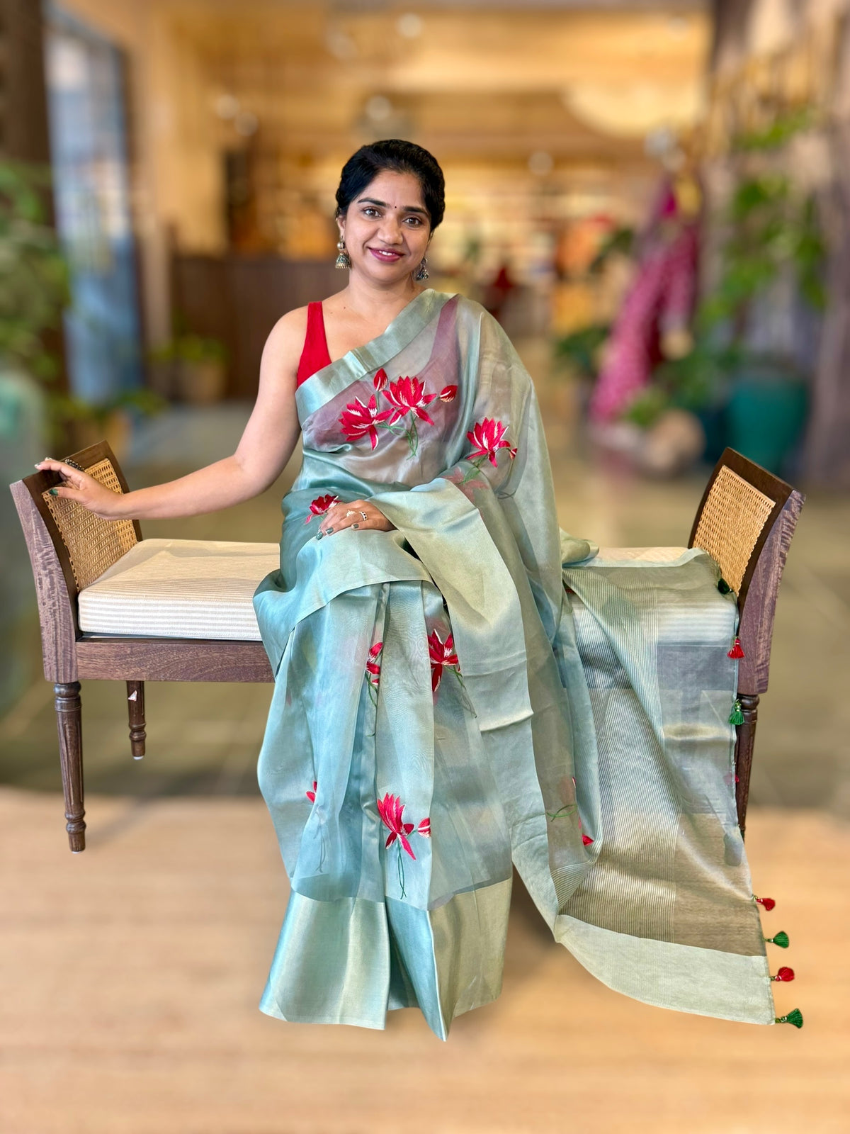 Teal Organza Saree with Lotus flower embroidery and Satin Borders.