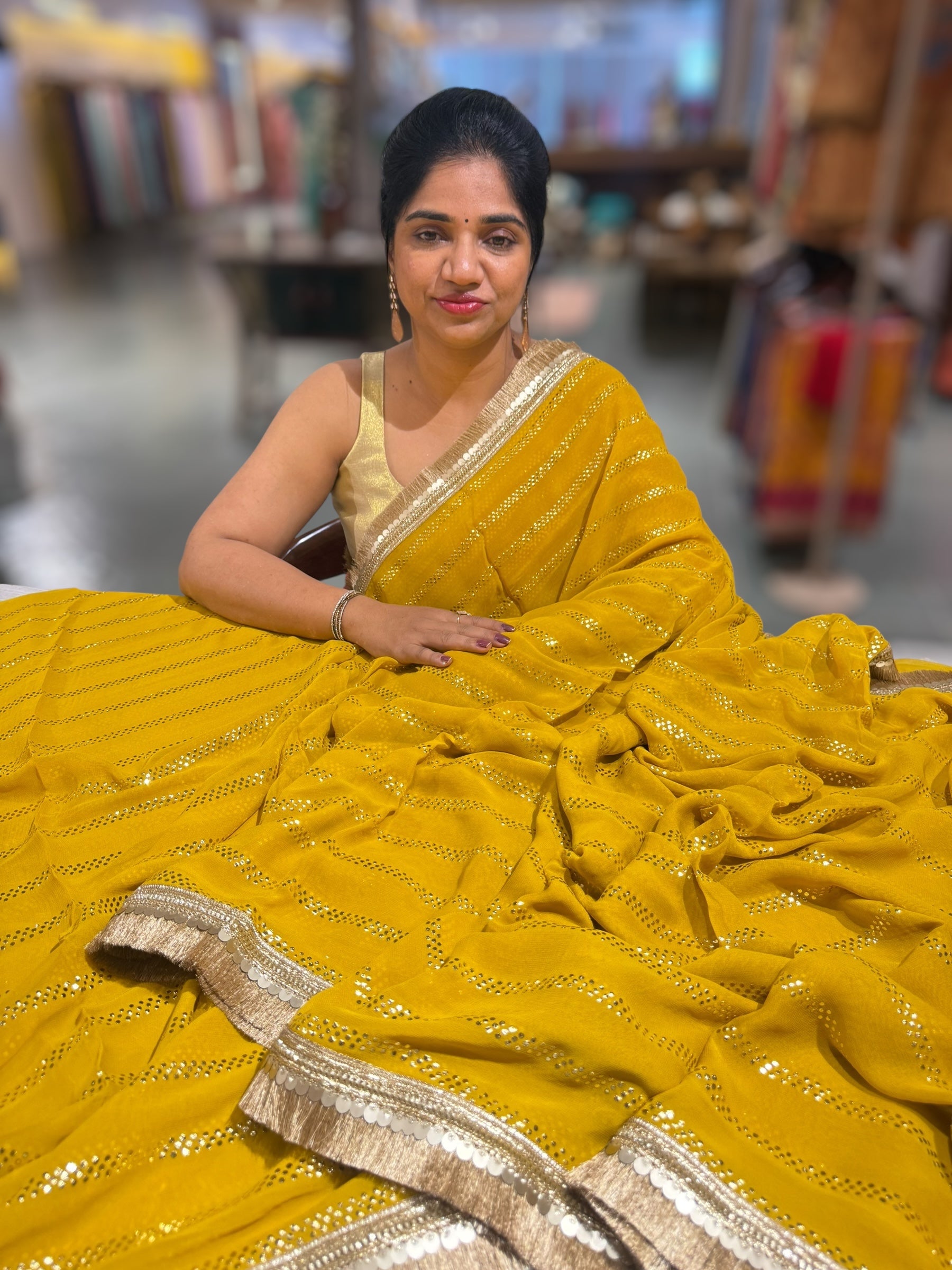 Stunning Black Georgette Saree with stick on Badla in stripes pattern and kiran Lace