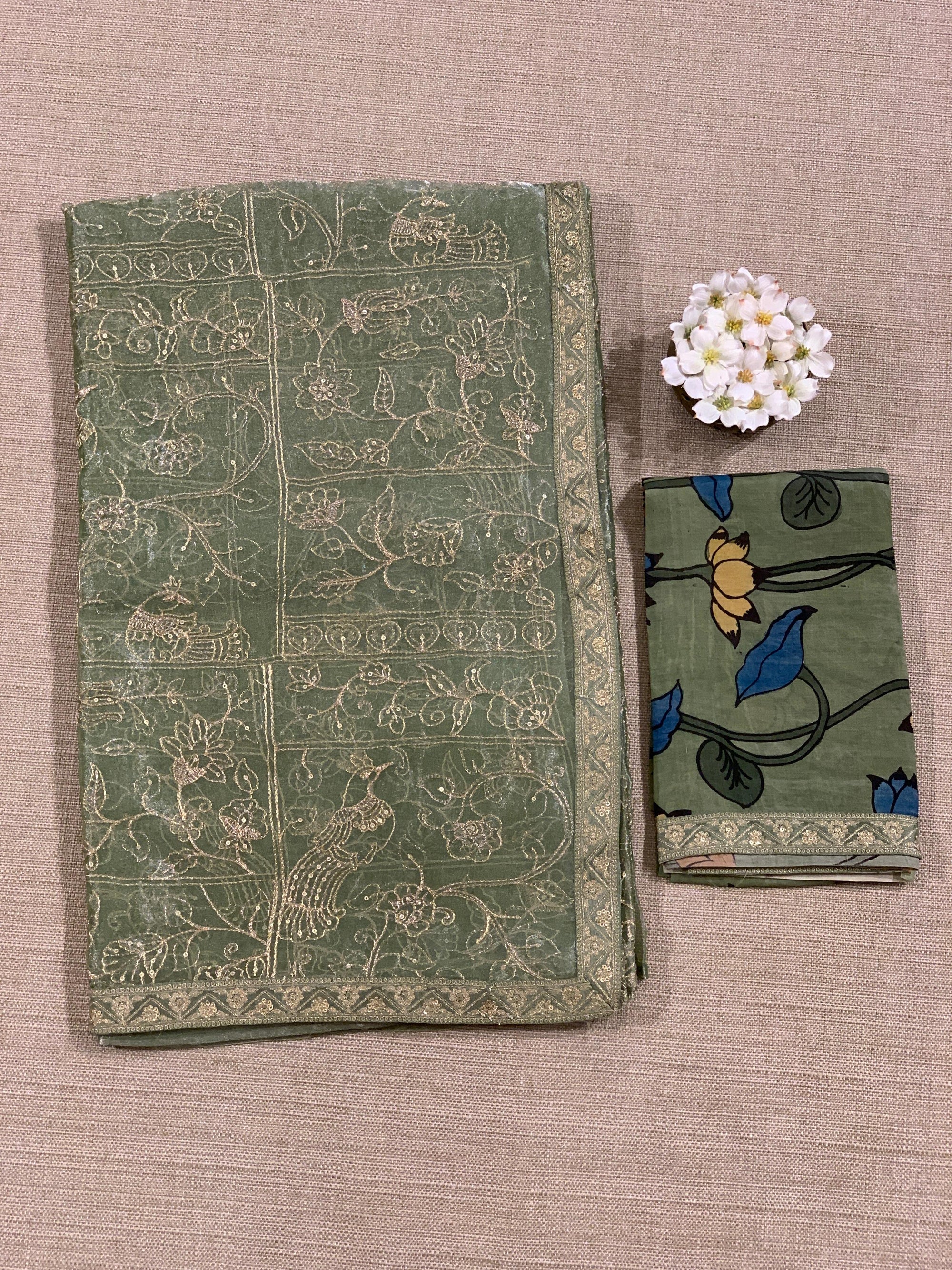Light olive Tissue saree with Allover zari embroidery hemlined with sabyasachi borders & paired with pen kalamkari blouse