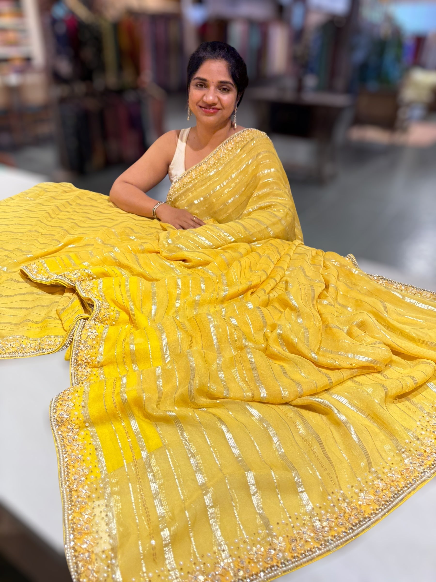 Yellow chiffon saree with handwork borders and stitched blouse