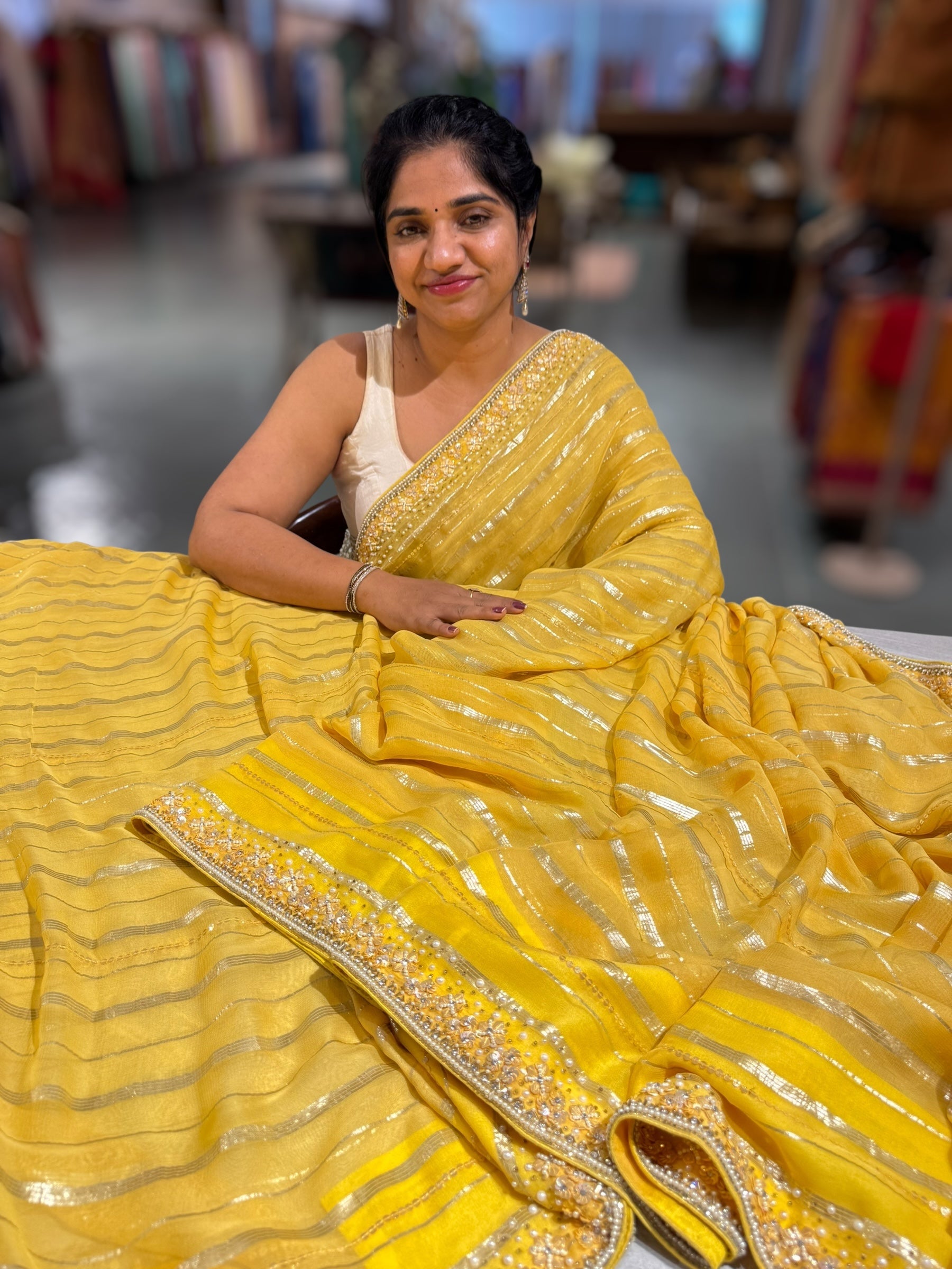 Yellow chiffon saree with handwork borders and stitched blouse