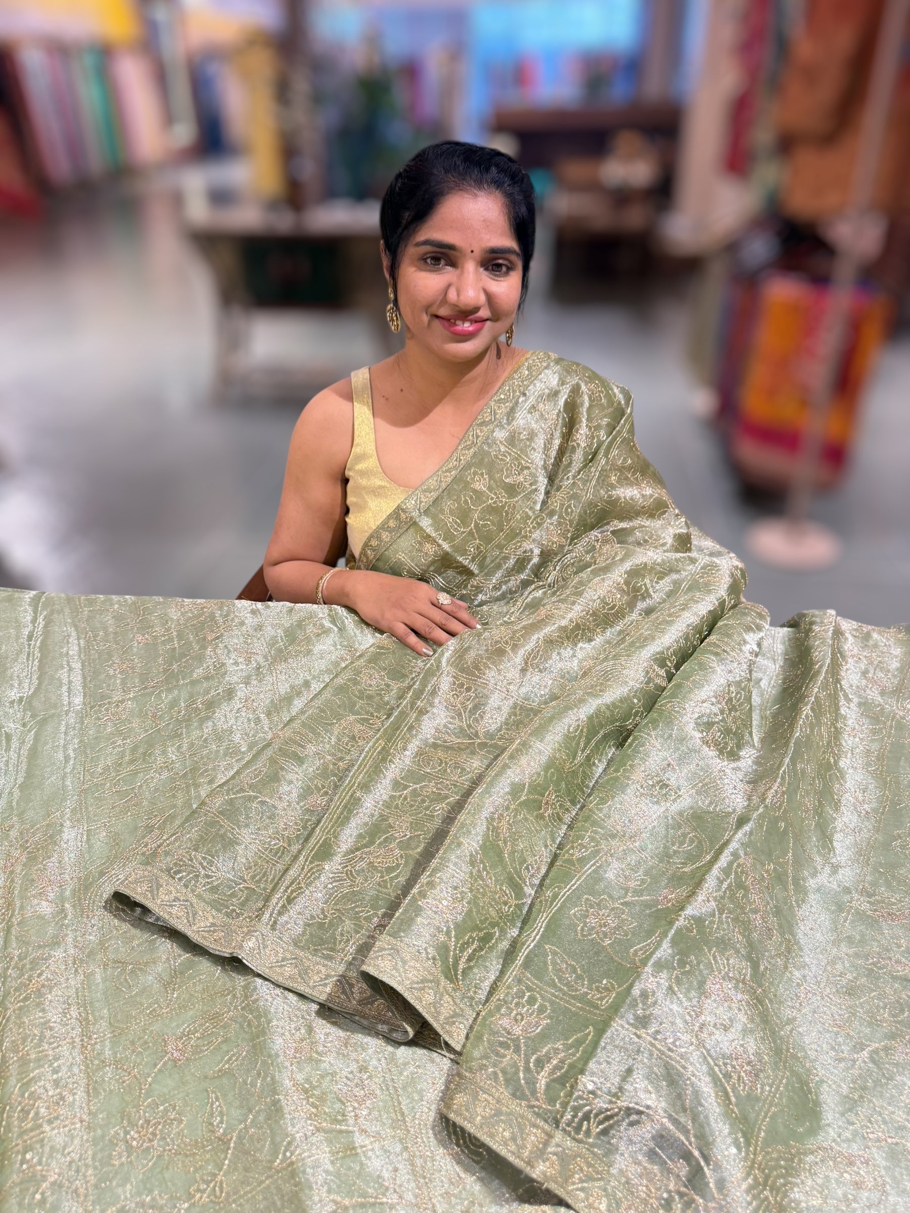 Light olive Tissue saree with Allover zari embroidery hemlined with sabyasachi borders & paired with pen kalamkari blouse