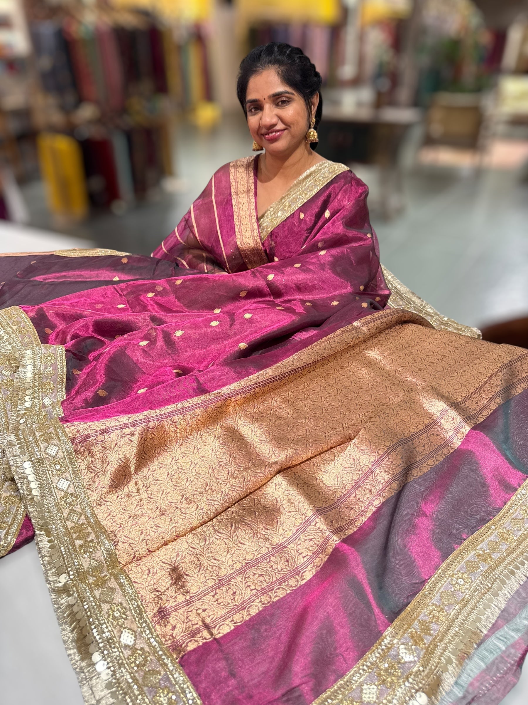 Wine Pure handloom Banarasi Tissue saree hemlined with Sabhyasachi style fringe laces .
