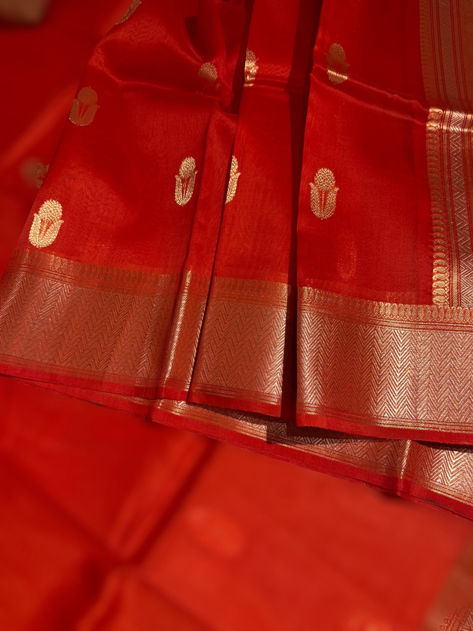 Orangish Red Premium Kora Banarasi Saree with heavy weaving borders and Raw mango style motifs