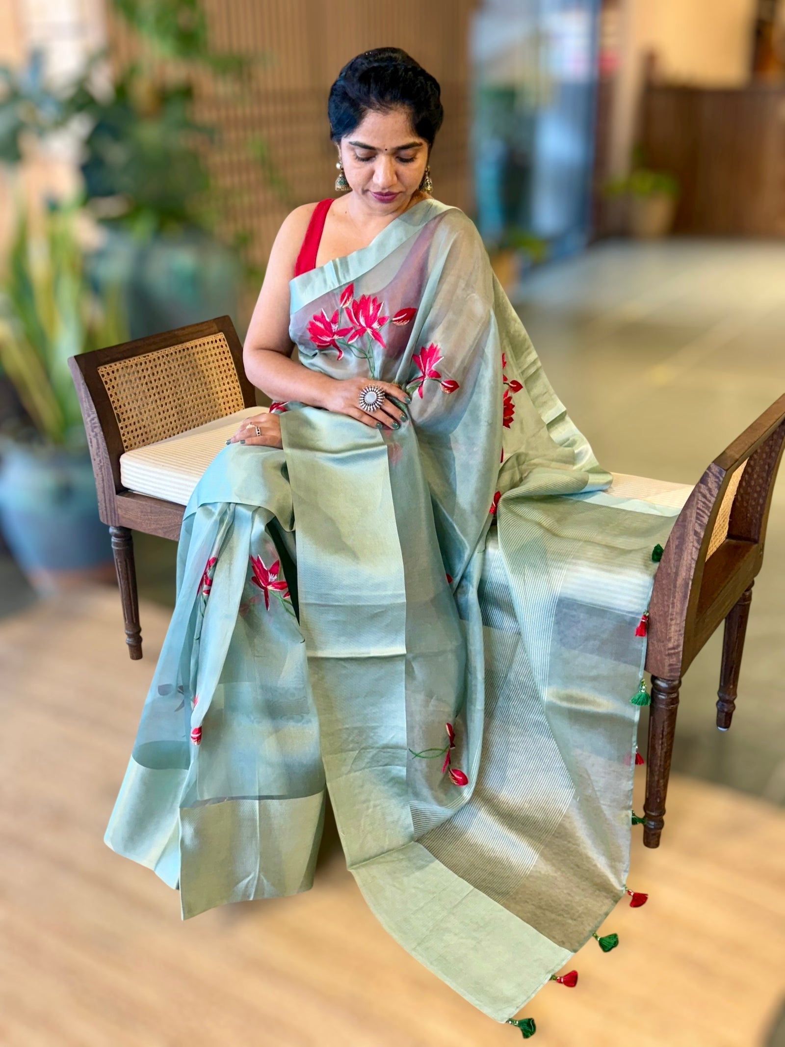 Teal Organza Saree with Lotus flower embroidery and Satin Borders.