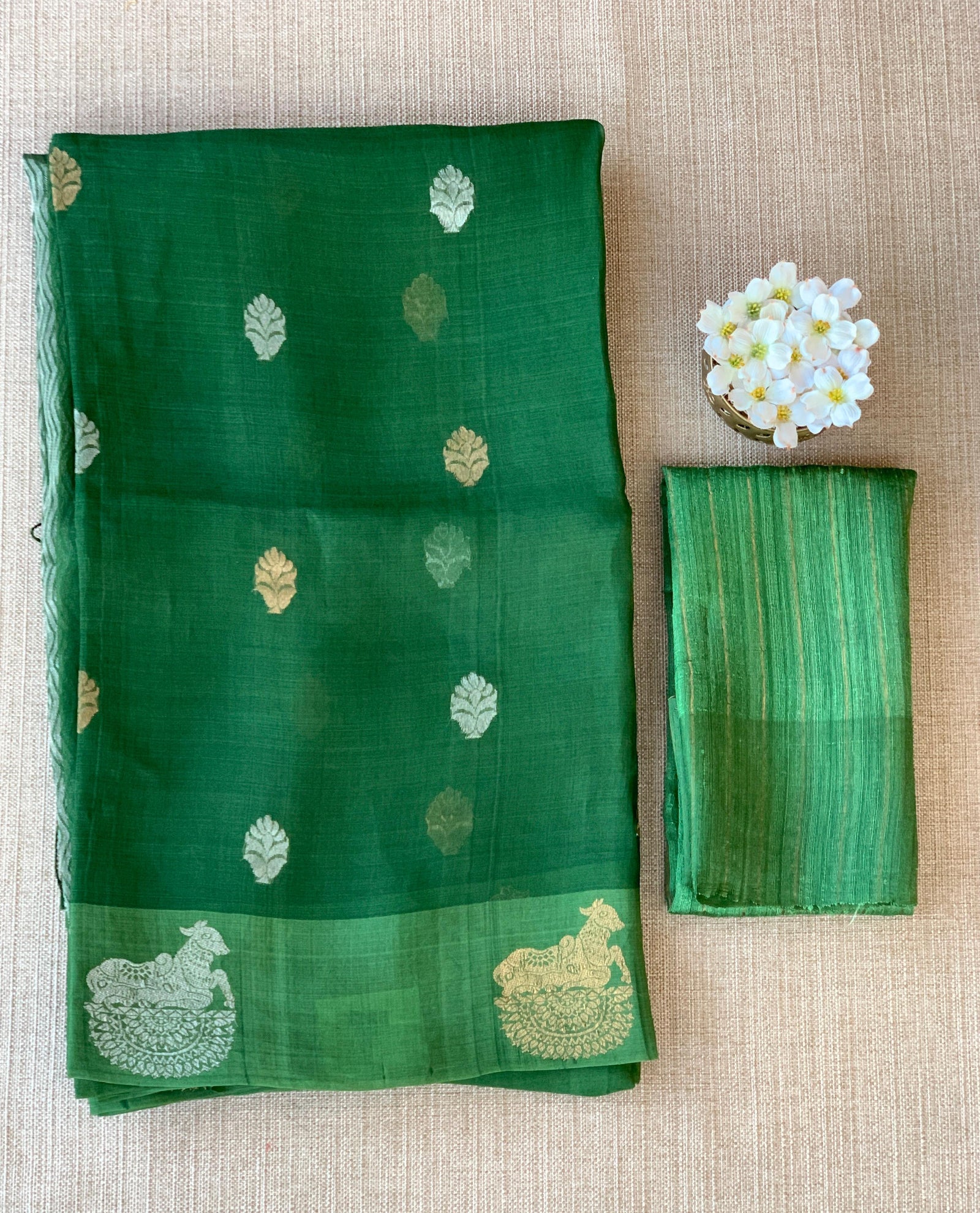 Emerald Green kora muslin sarees with kaduwa woven nandi motif border