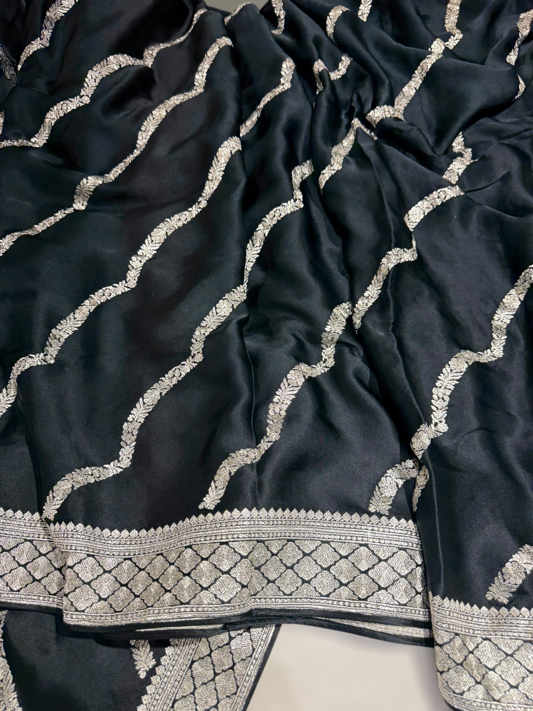Black Designer Satin Saree with stunning embroidery paired with Silver tissue Pythani embroidered blouse