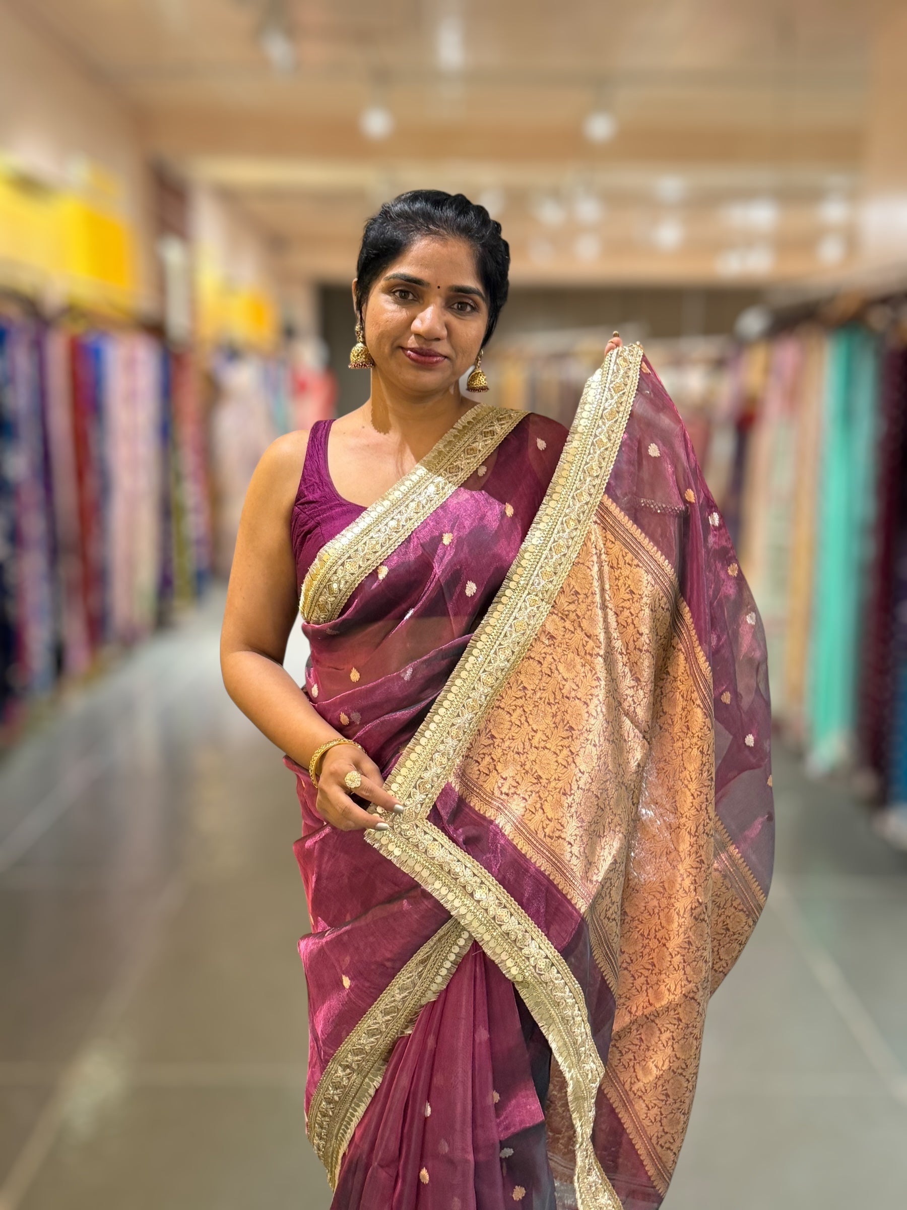 Wine Pure handloom Banarasi Tissue saree hemlined with Sabhyasachi style fringe laces .