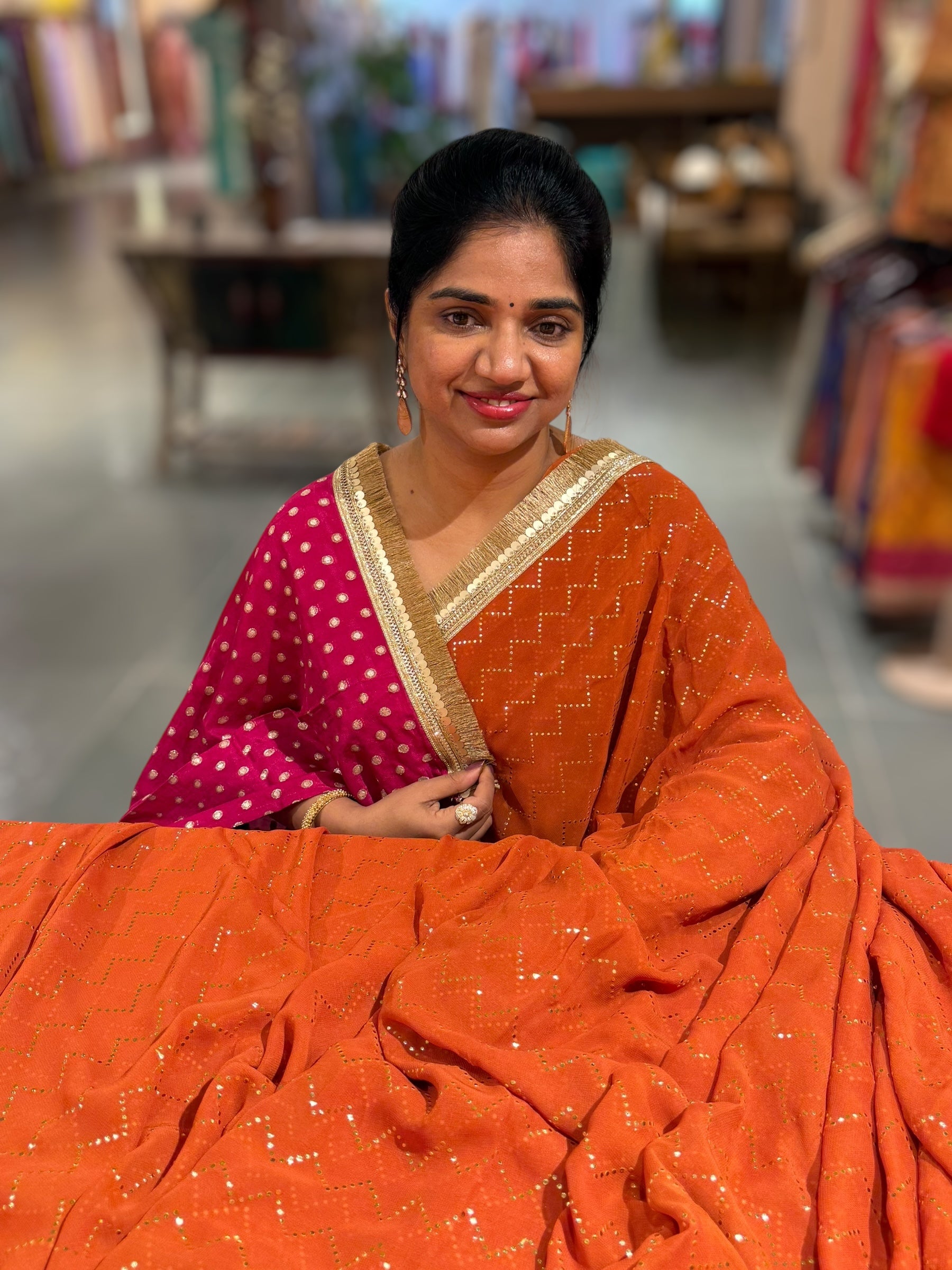 Rust Orange Georgette Saree with stick on Badla in zigzag pattern