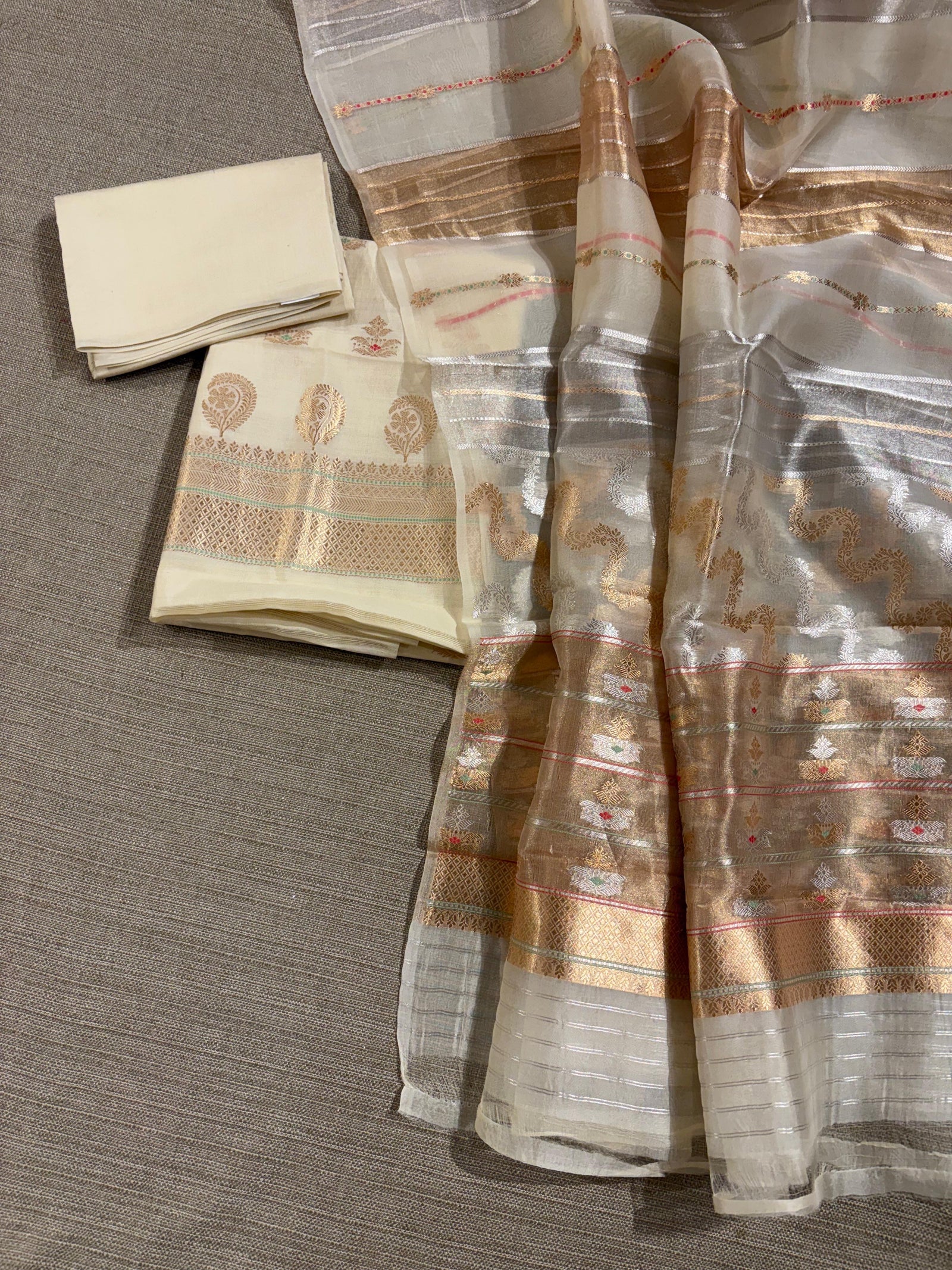 Ivory color Chiniya silk suit set with oaduwa woven meenakari motifs paired with heavy kora banarasi dupatta