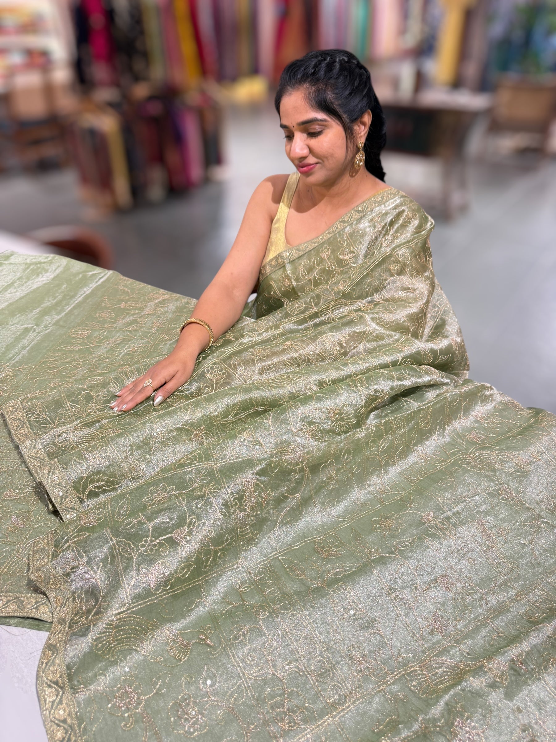 Light olive Tissue saree with Allover zari embroidery hemlined with sabyasachi borders & paired with pen kalamkari blouse