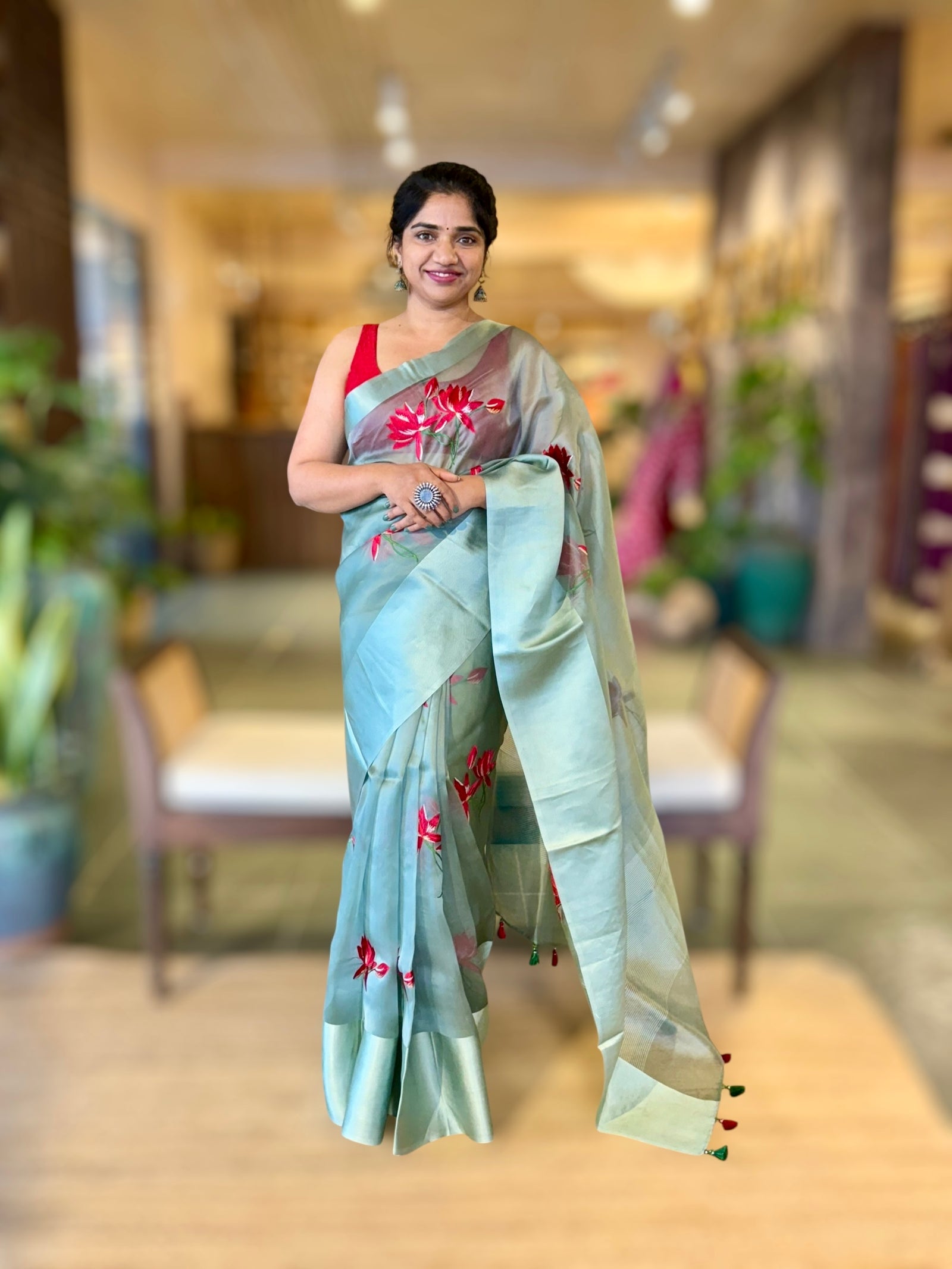 Teal Organza Saree with Lotus flower embroidery and Satin Borders.