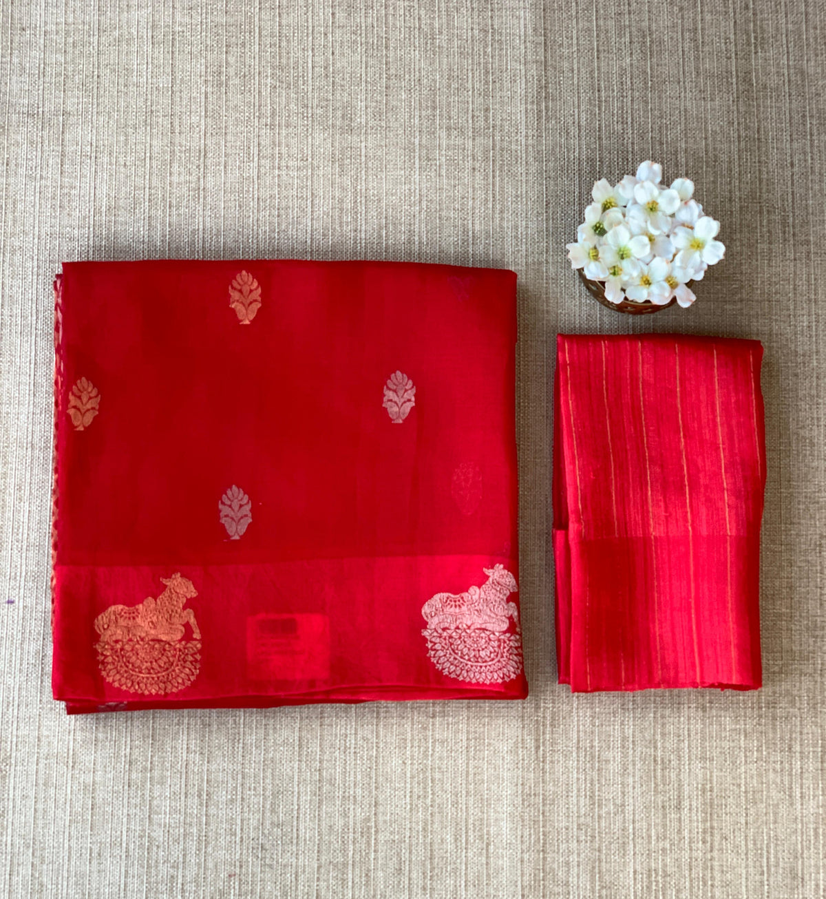 Red kora muslin sarees with kaduwa woven nandi motif border