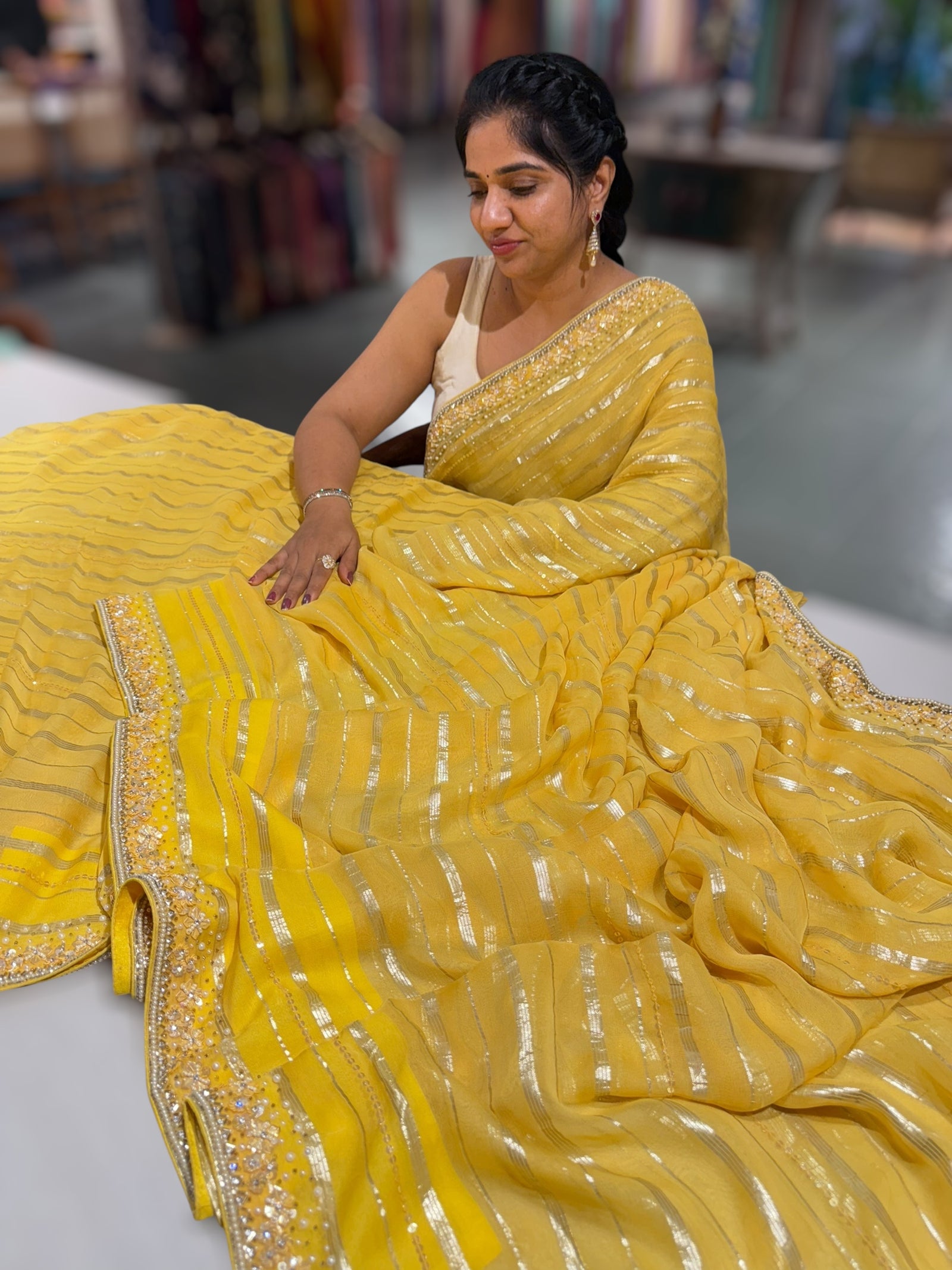 Yellow chiffon saree with handwork borders and stitched blouse