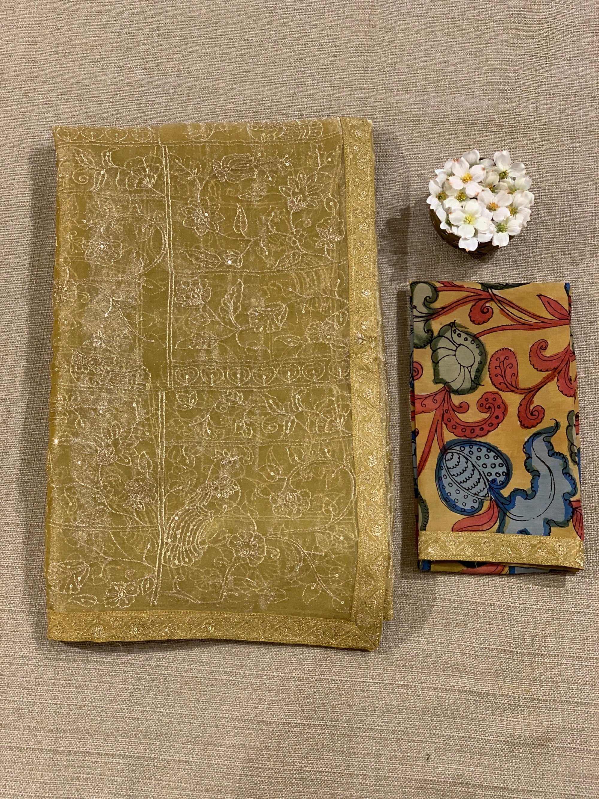 Yellow gold Tissue saree with Allover zari embroidery hemlined with sabyasachi borders & paired with pen kalamkari blouse