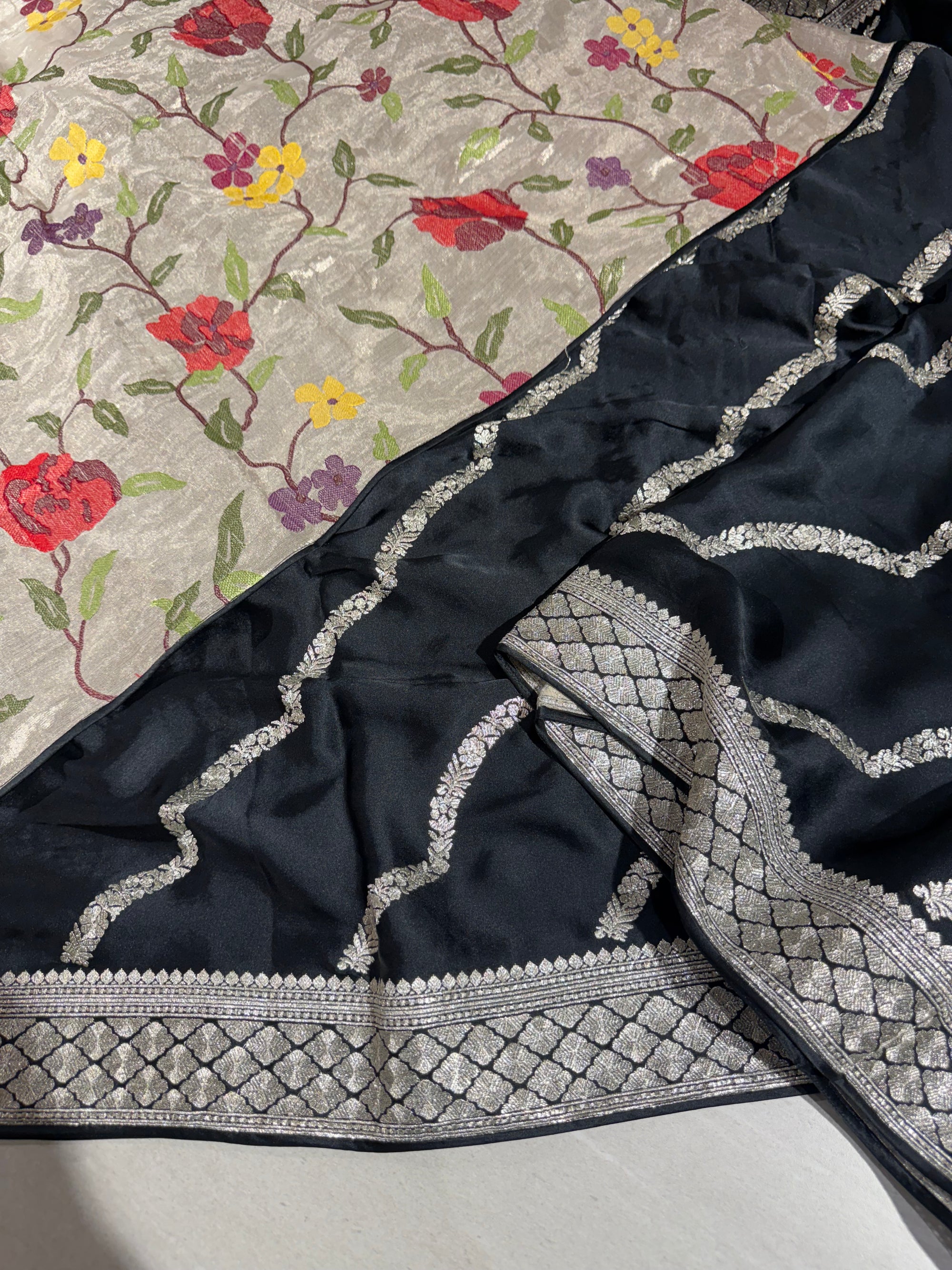 Black Designer Satin Saree with stunning embroidery paired with Silver tissue Pythani embroidered blouse