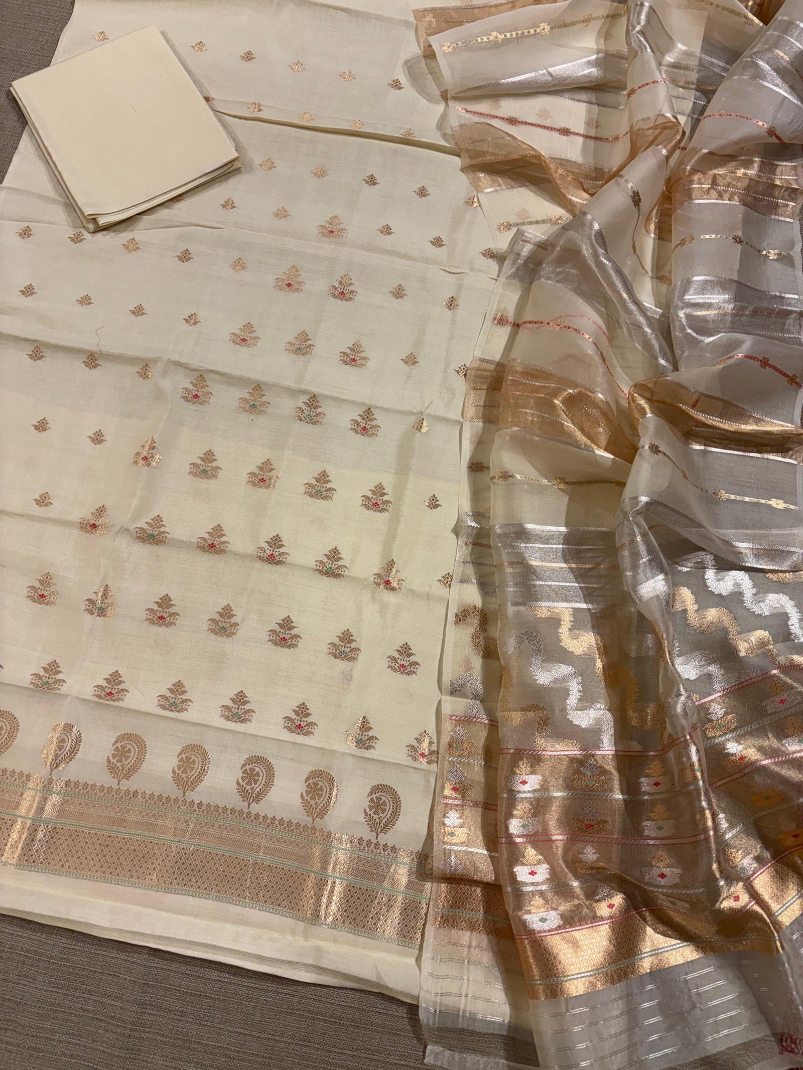 Ivory color Chiniya silk suit set with oaduwa woven meenakari motifs paired with heavy kora banarasi dupatta