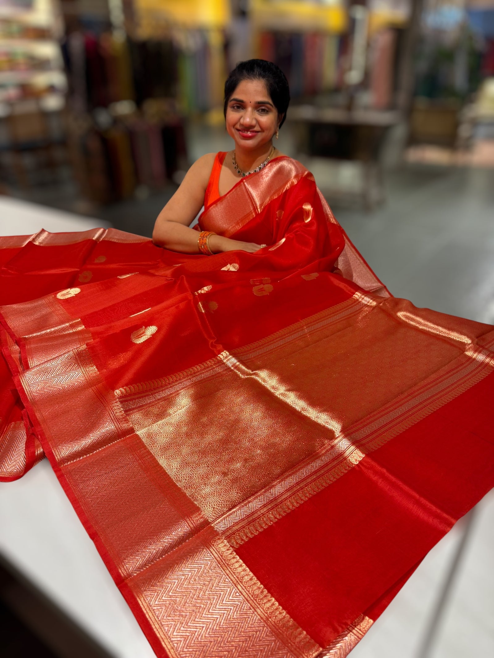 Orangish Red Premium Kora Banarasi Saree with heavy weaving borders and Raw mango style motifs