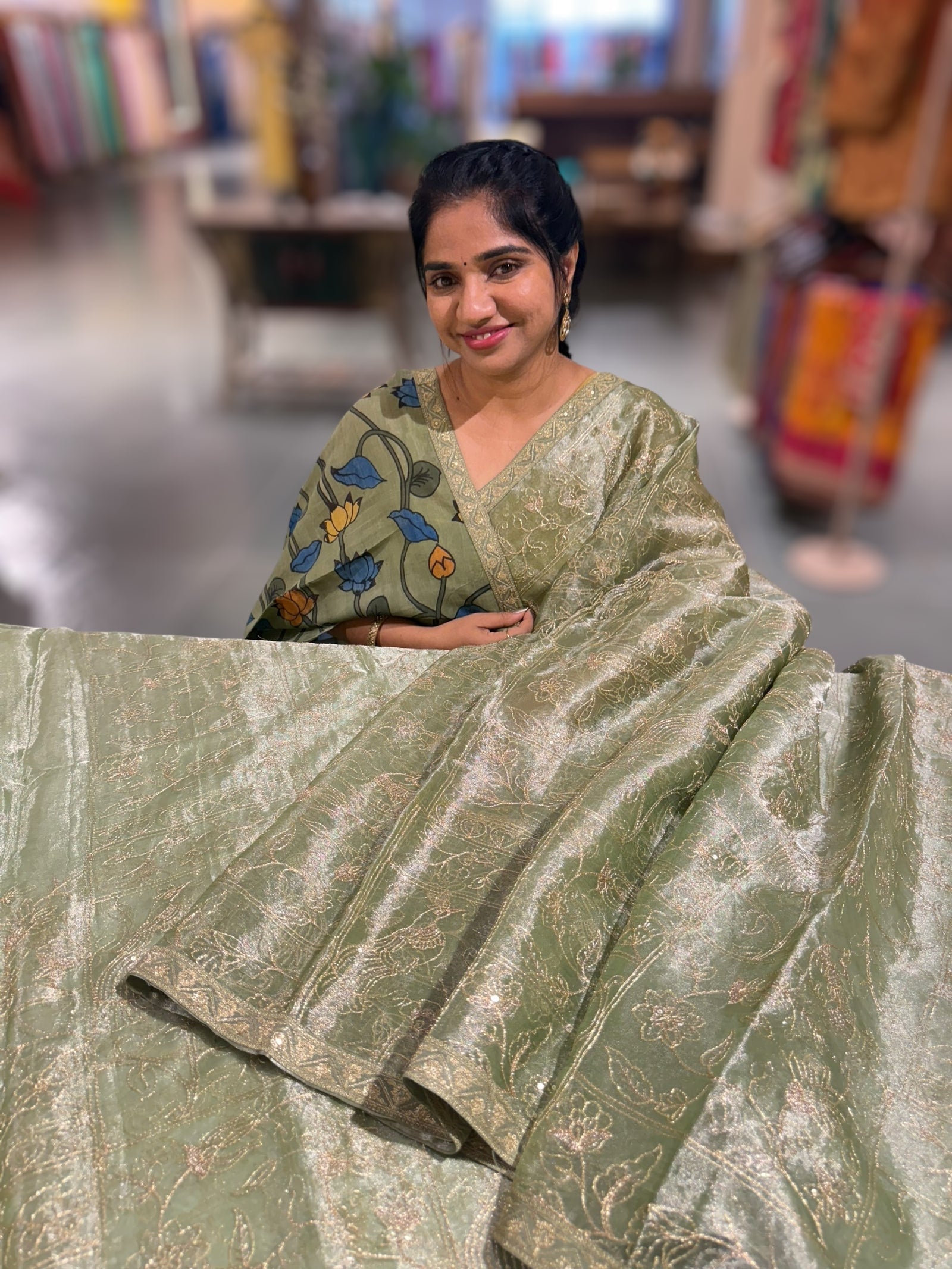 Light olive Tissue saree with Allover zari embroidery hemlined with sabyasachi borders & paired with pen kalamkari blouse