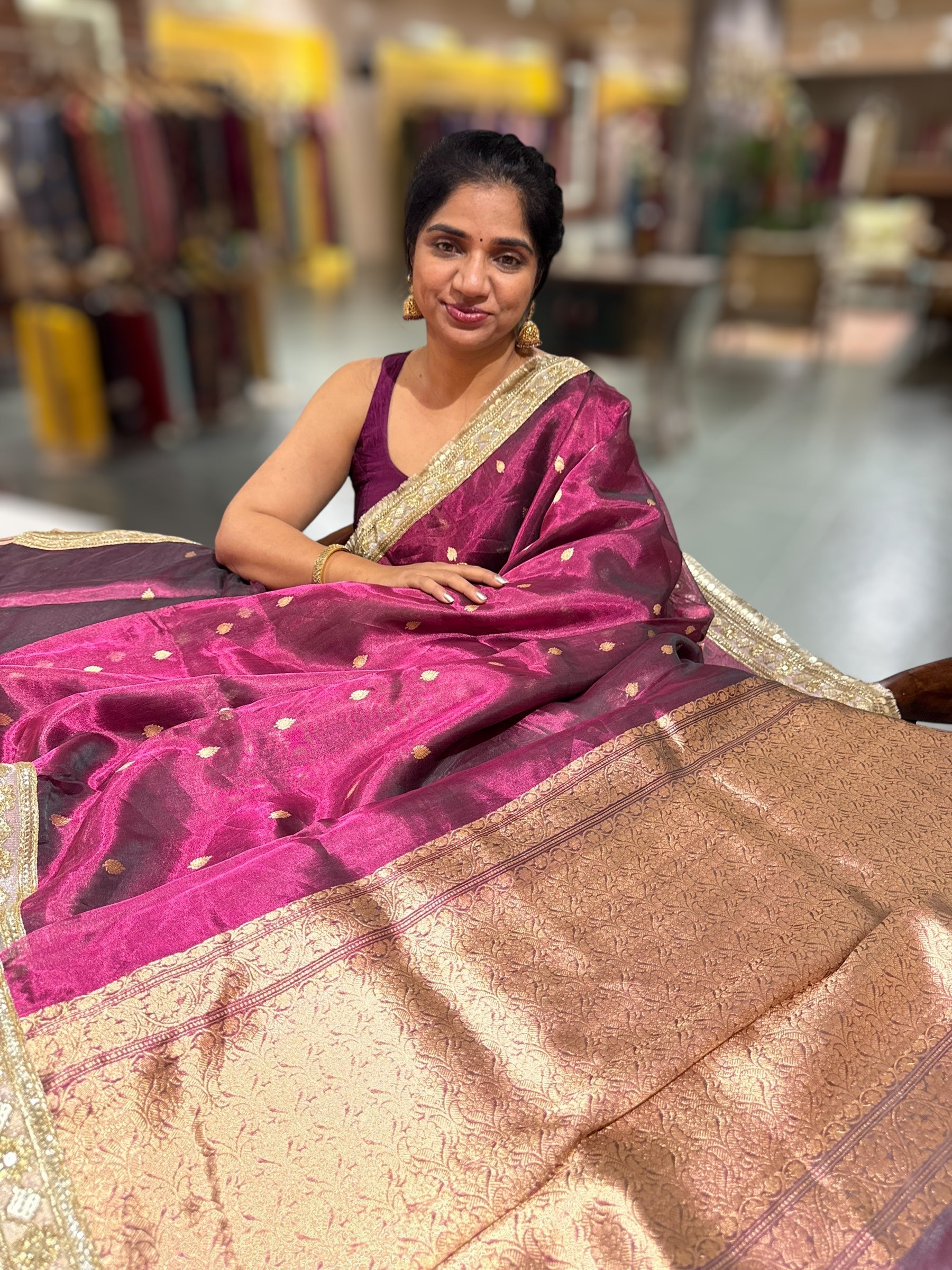 Wine Pure handloom Banarasi Tissue saree hemlined with Sabhyasachi style fringe laces .