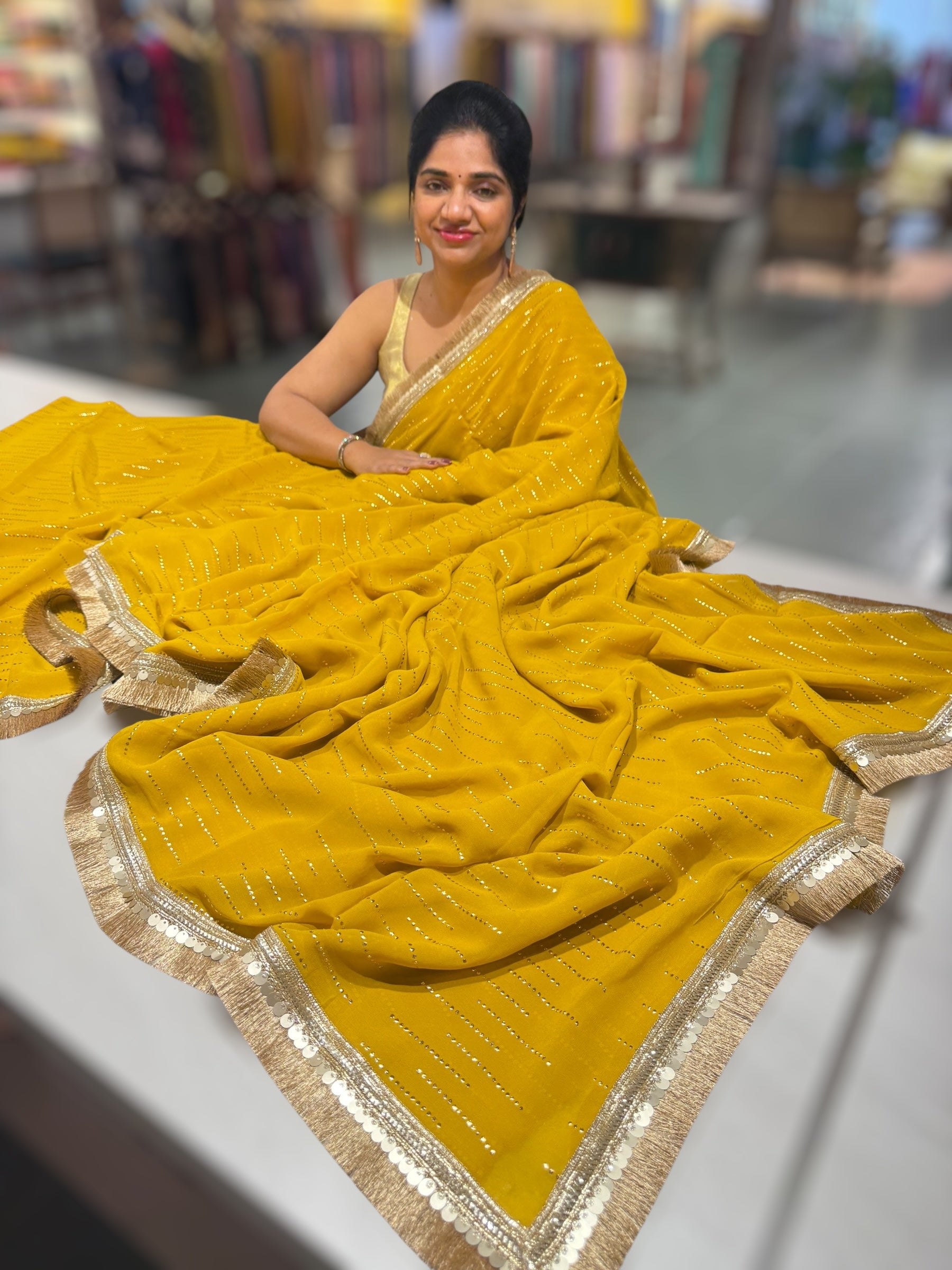 Yellow light Georgette Saree with stick on Badla in stripes pattern and kiran Lace