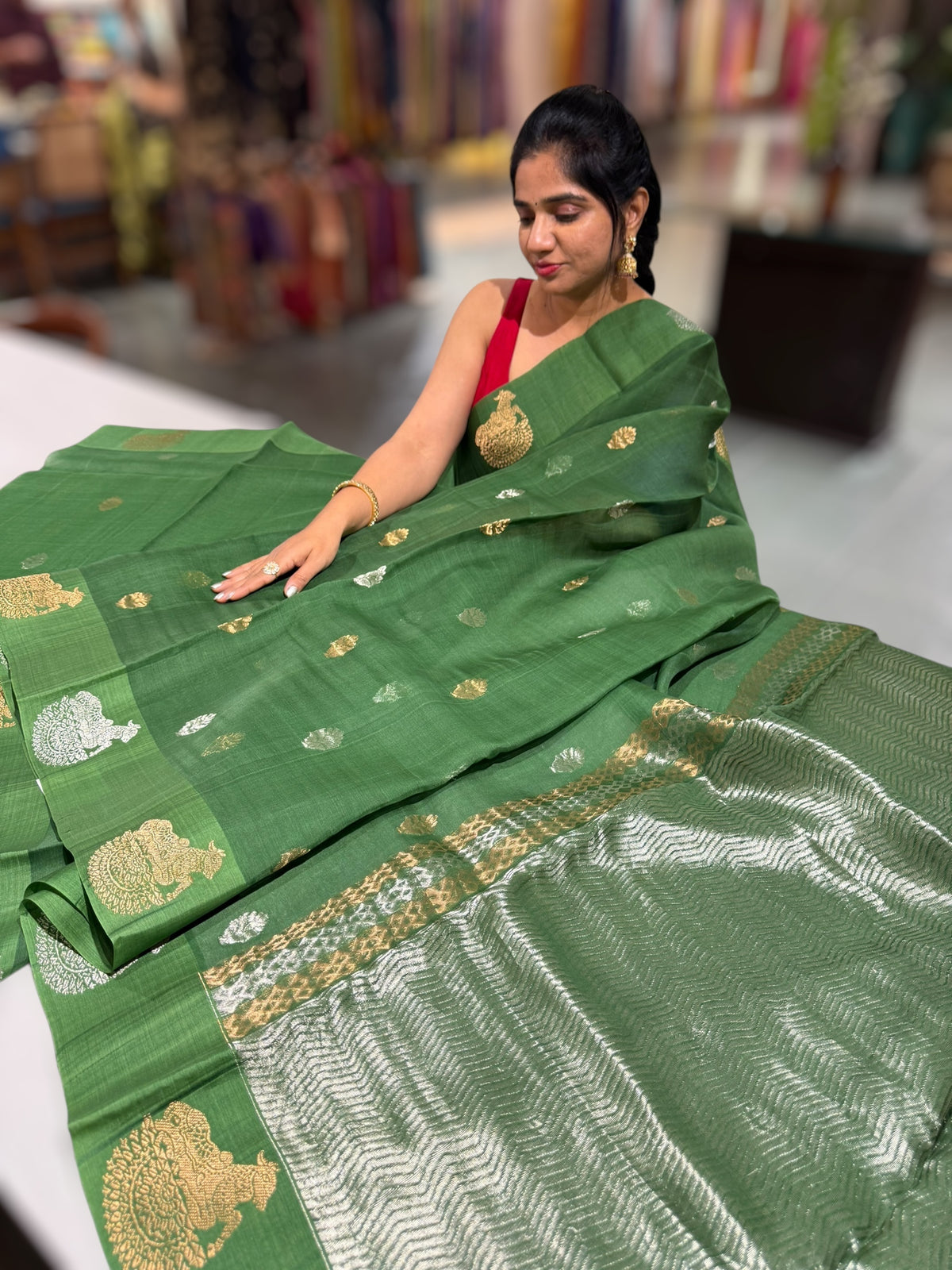 Emerald Green kora muslin sarees with kaduwa woven nandi motif border