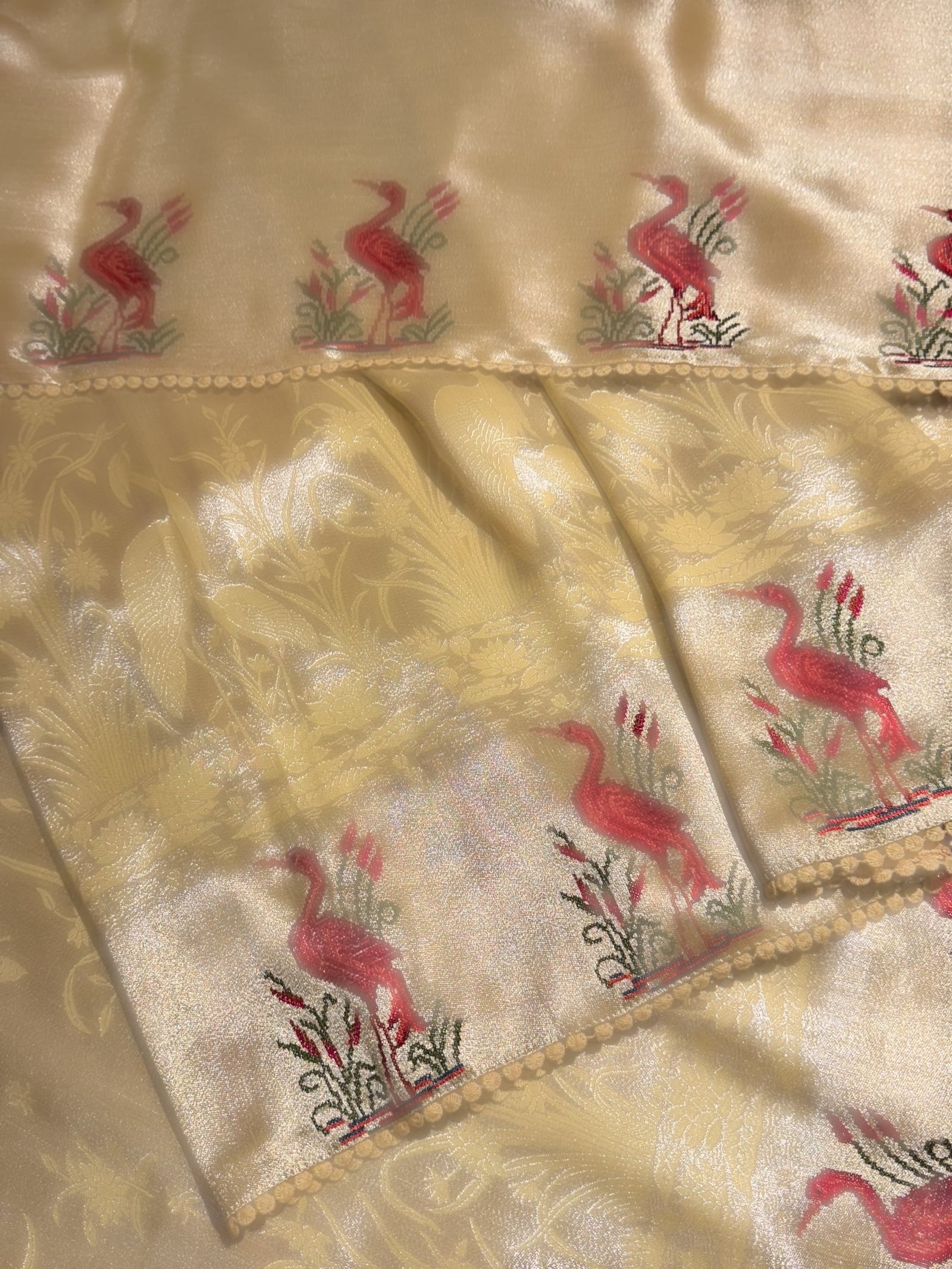 Pastel yellow Banarasi Brocade tissue saree with tonchui style weaving & petite point embroidered swan border