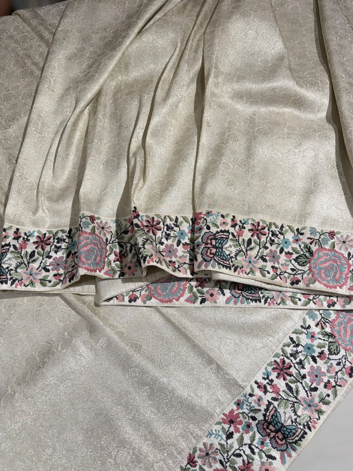 Half White Banarasi brocade Silk Saree with Petite Point Embroidered Border.