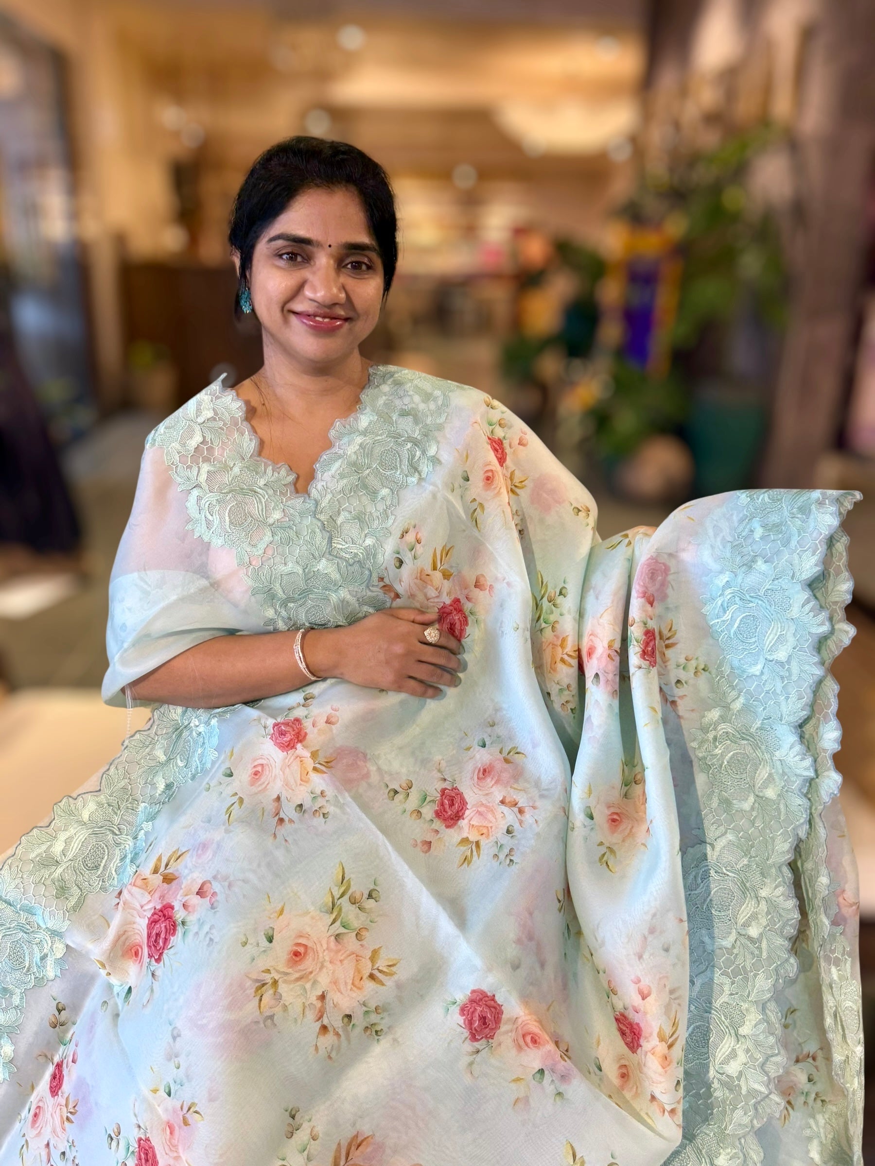 SeaBlue Printed Organza Saree With Chantilly Lace Style Embroidered Border.
