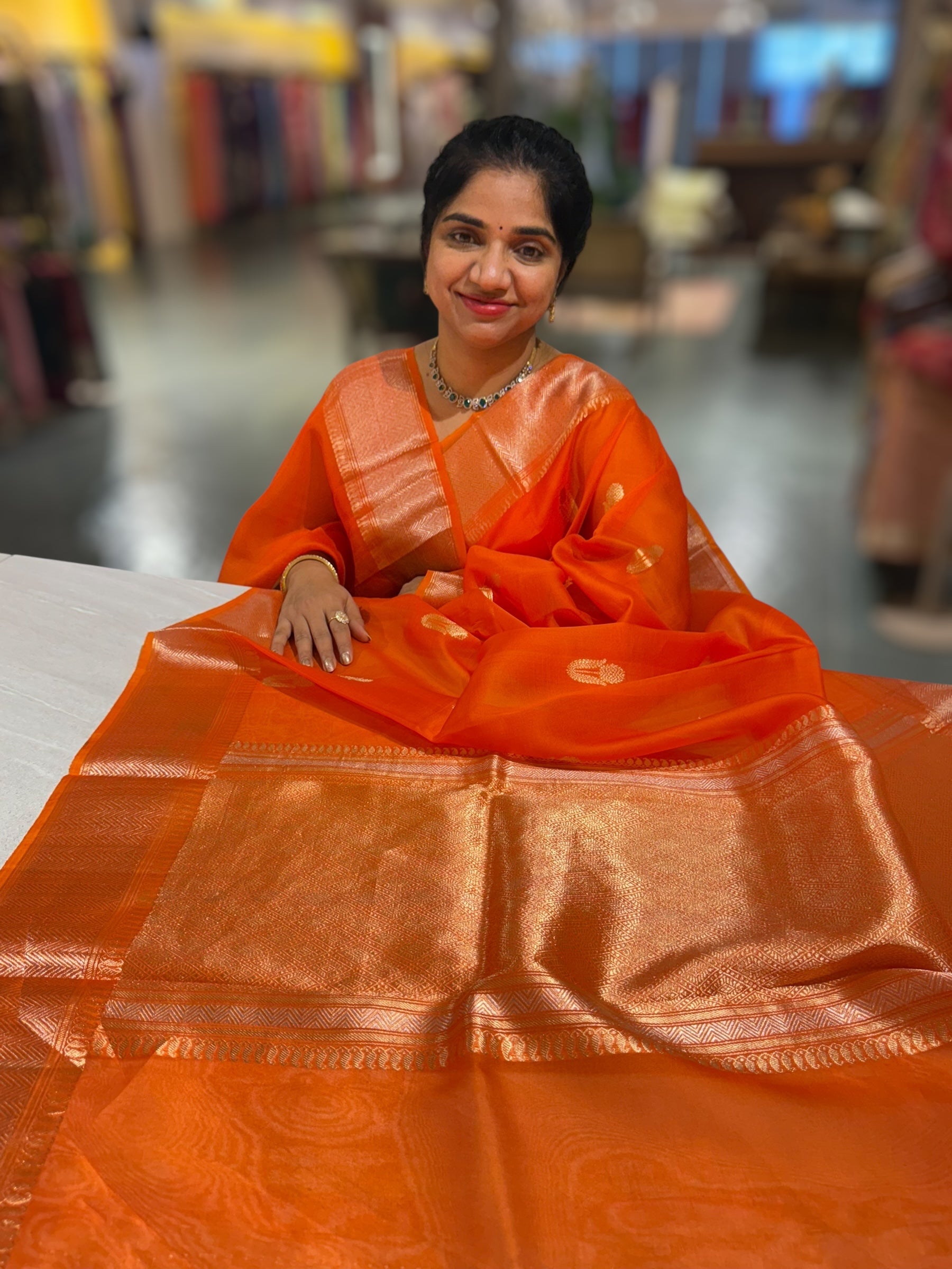 Orange Premium Kora Banarasi Saree with heavy weaving borders and Raw mango style motifs