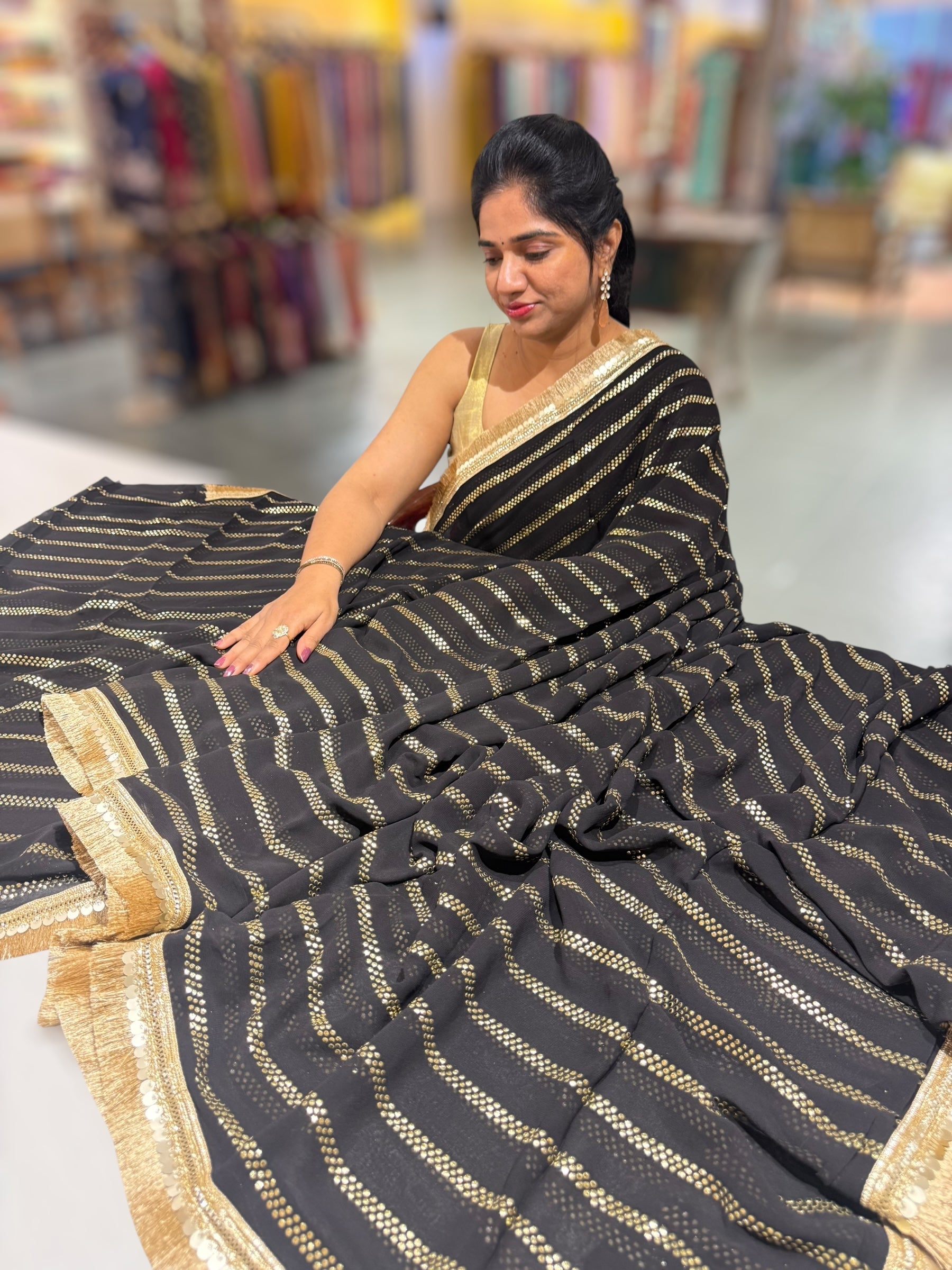 Black Georgette Saree with stick on Badla in stripes pattern and kiran Lace
