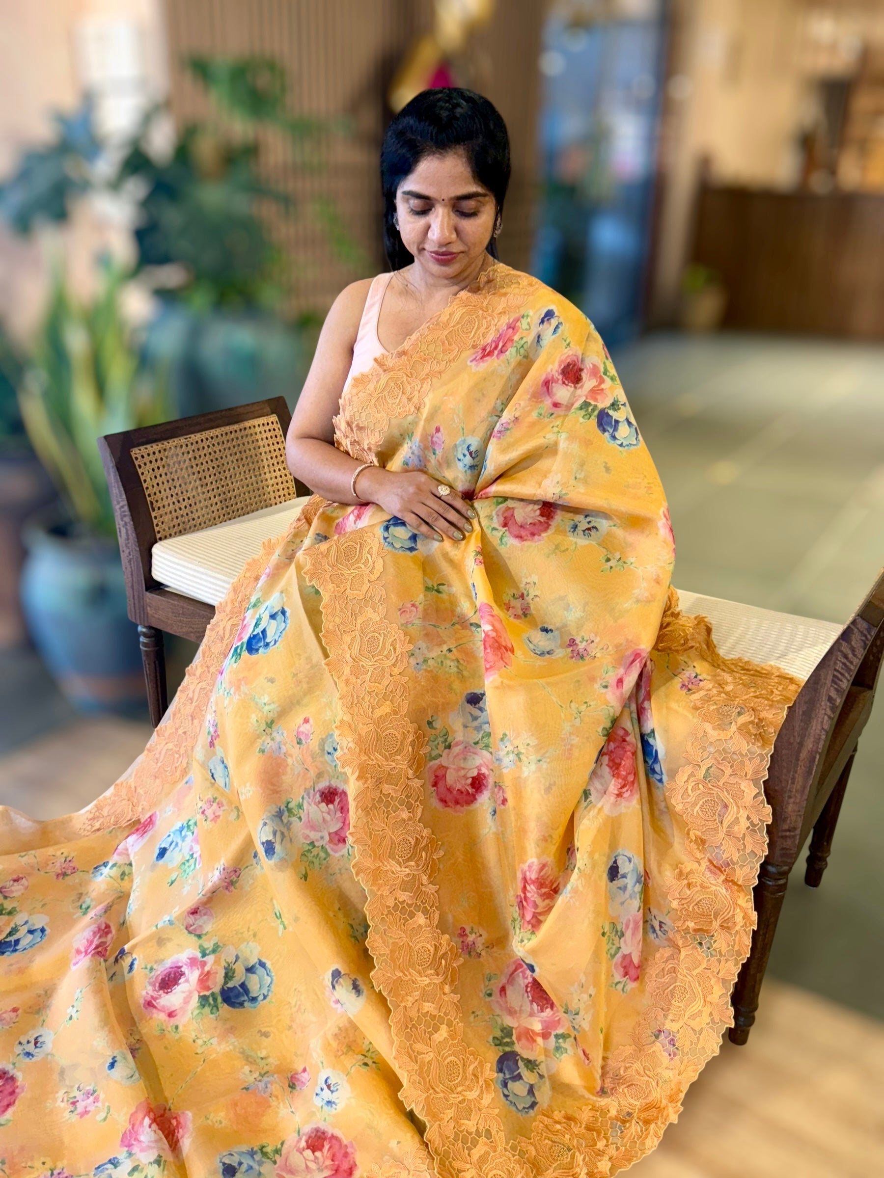 Mustardish Orange Printed Organza Saree With Chantilly Lace Style Embroidered Border.