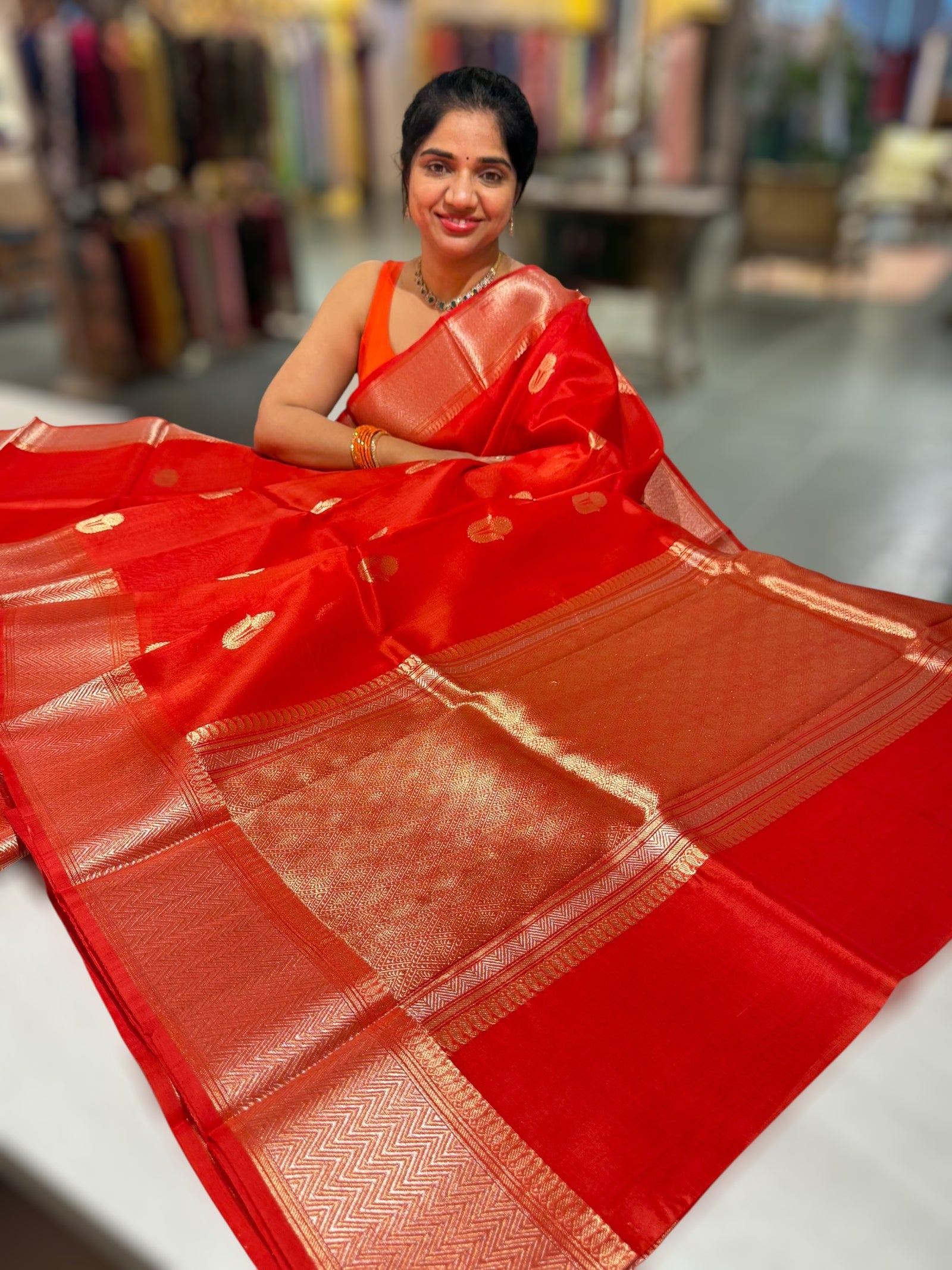Orangish Red Premium Kora Banarasi Saree with heavy weaving borders and Raw mango style motifs