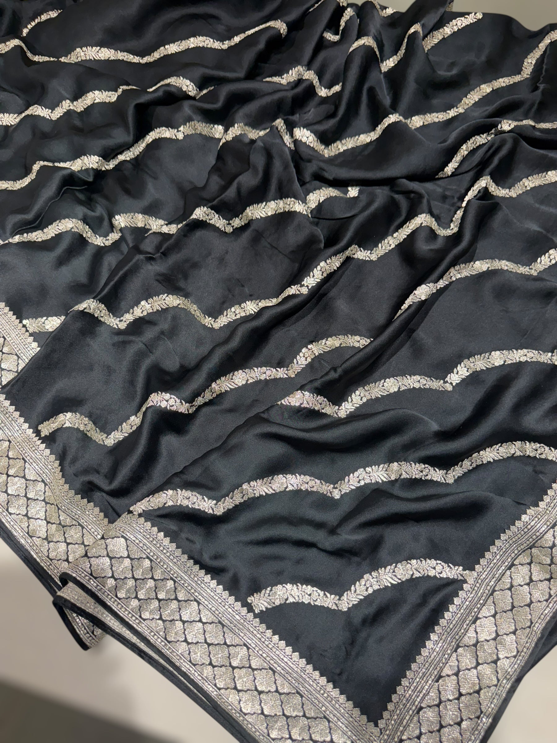 Black Designer Satin Saree with stunning embroidery paired with Silver tissue Pythani embroidered blouse