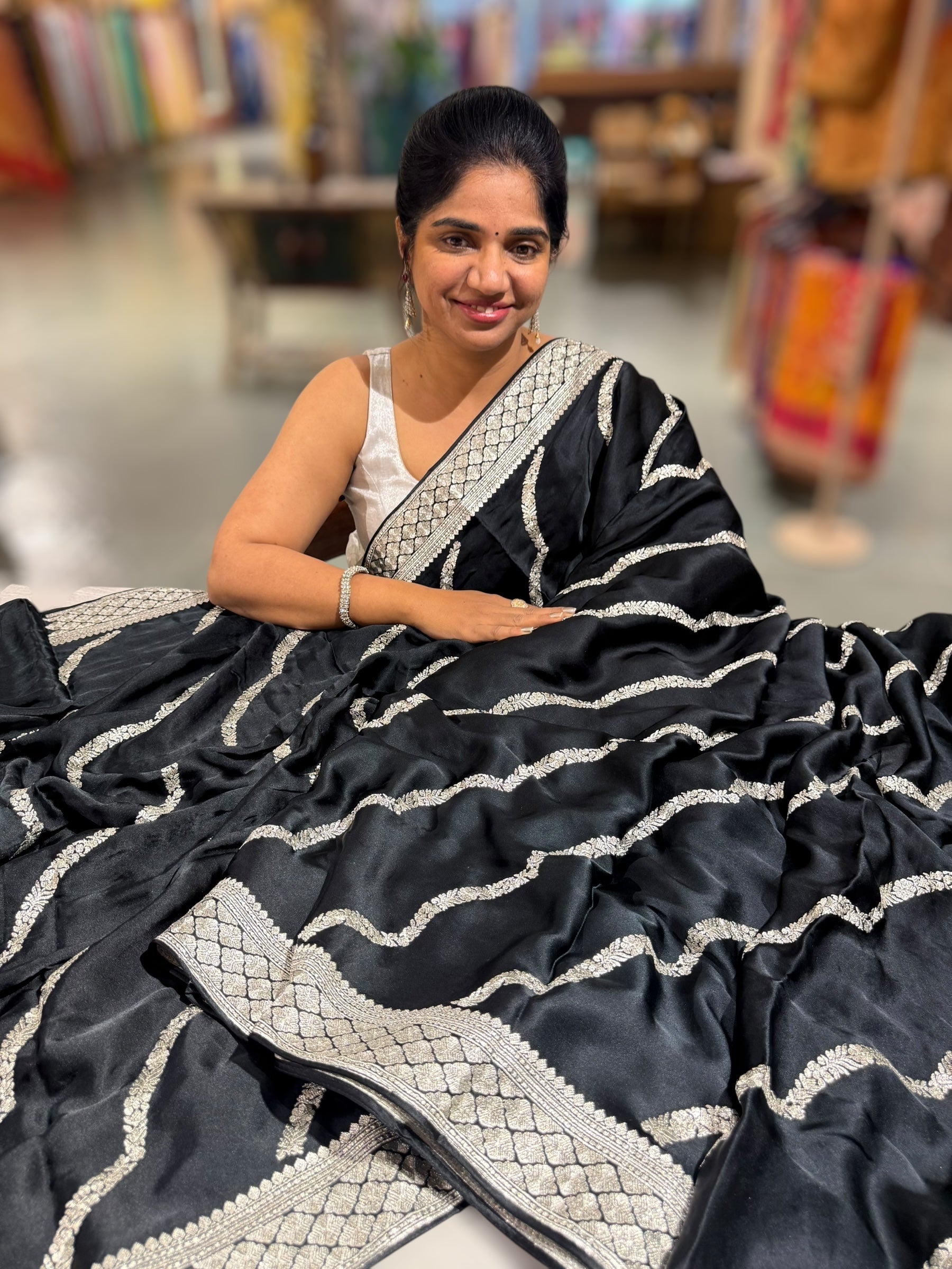Black Designer Satin Saree with stunning embroidery paired with Silver tissue Pythani embroidered blouse