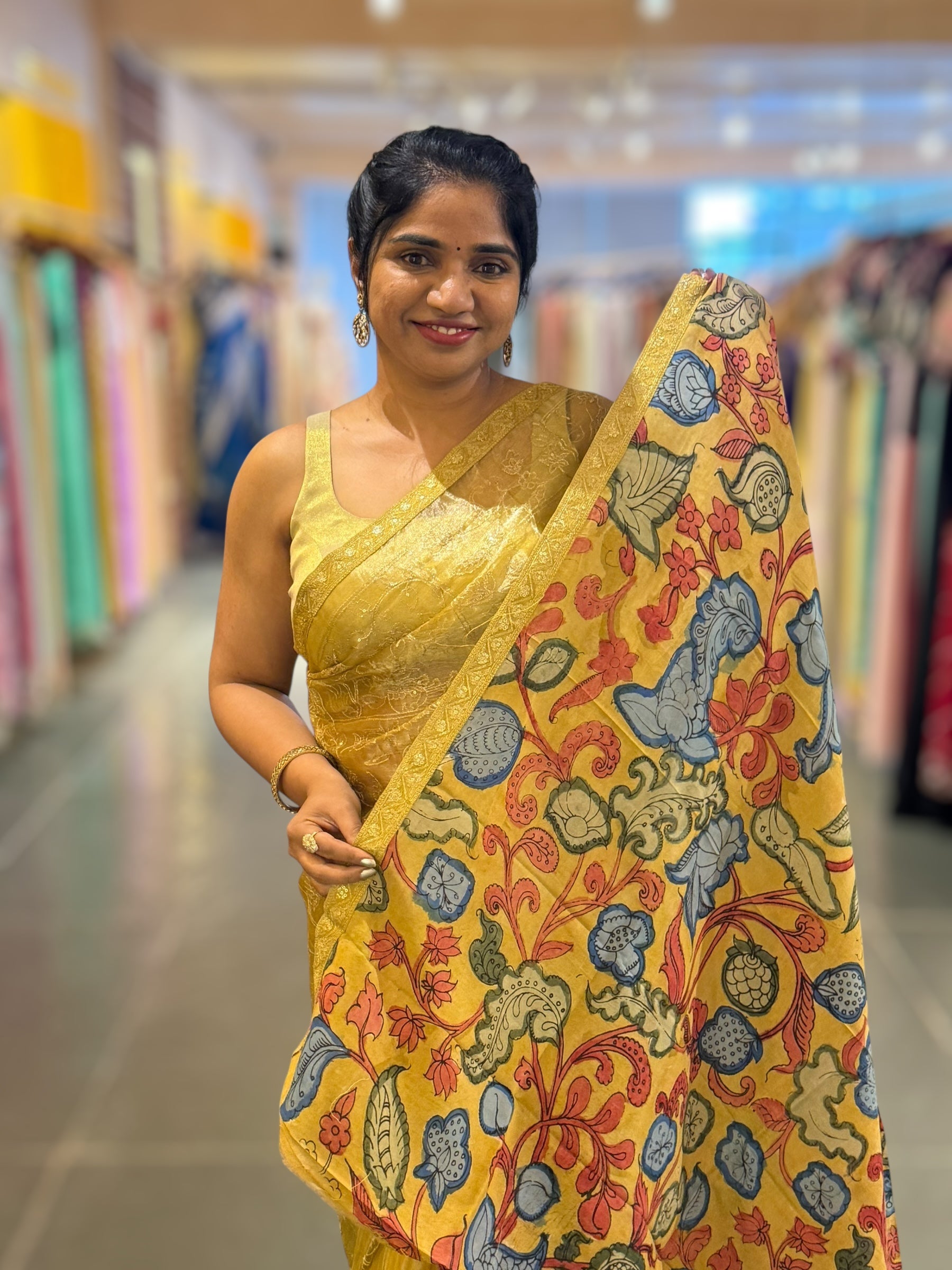 Yellow gold Tissue saree with Allover zari embroidery hemlined with sabyasachi borders & paired with pen kalamkari blouse