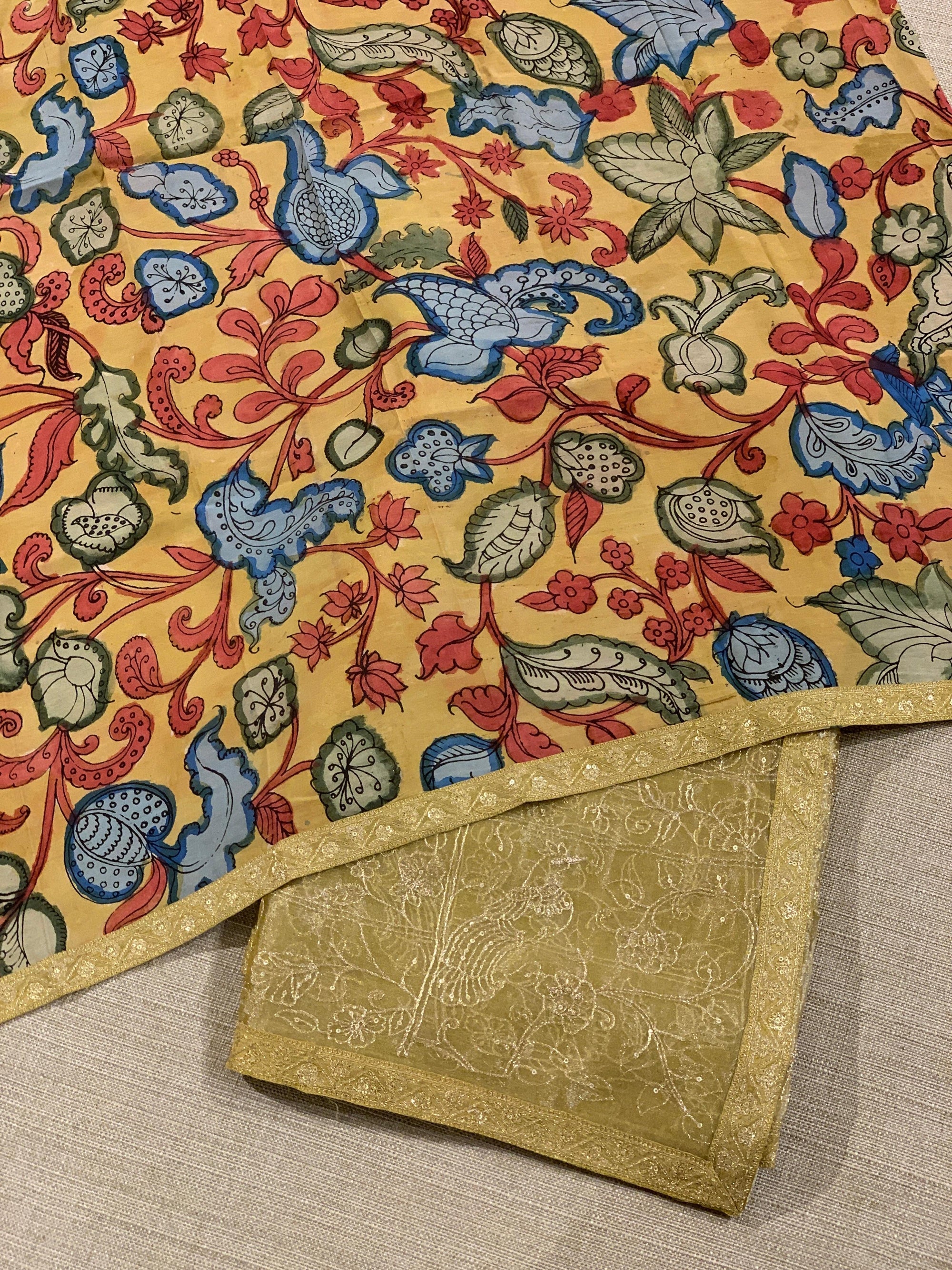 Yellow gold Tissue saree with Allover zari embroidery hemlined with sabyasachi borders & paired with pen kalamkari blouse