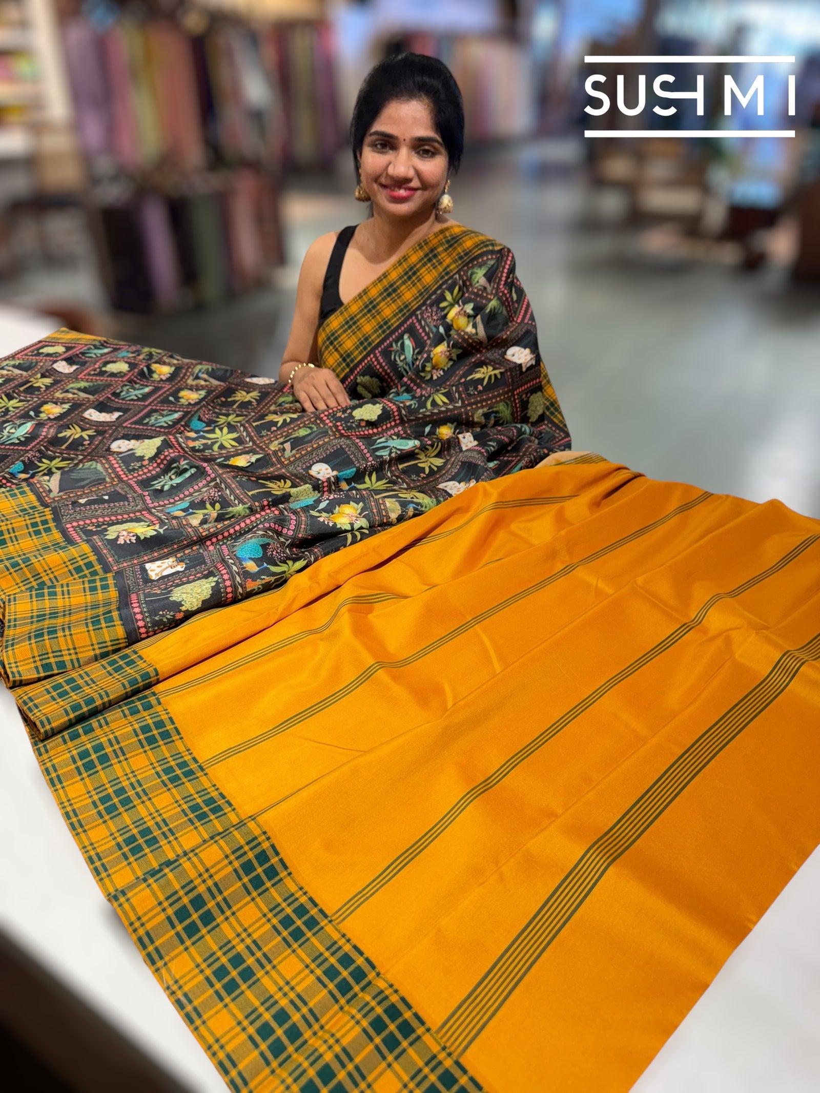 Black printed soft silk saree with burberry checks border : D62F033