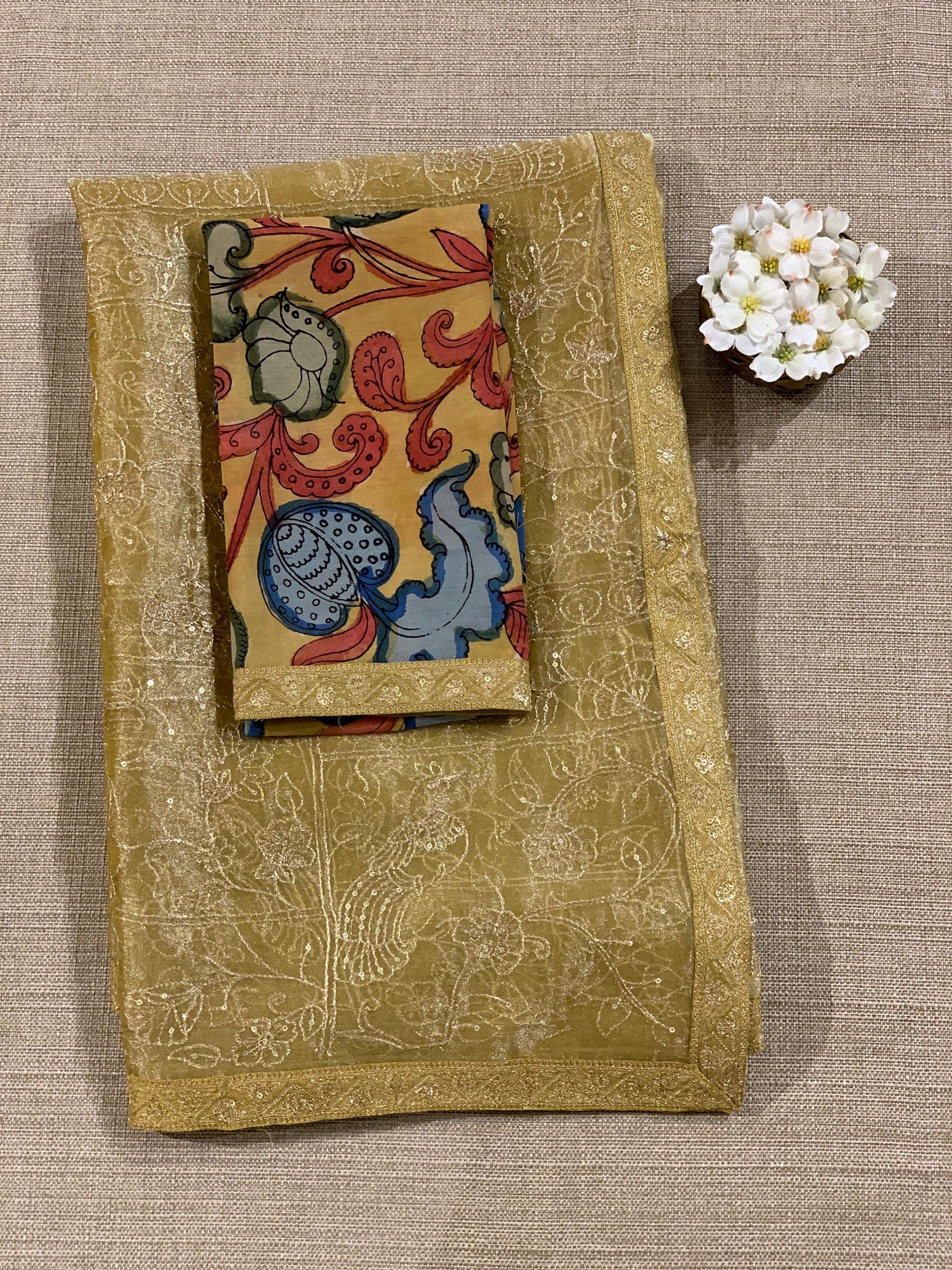 Yellow gold Tissue saree with Allover zari embroidery hemlined with sabyasachi borders & paired with pen kalamkari blouse