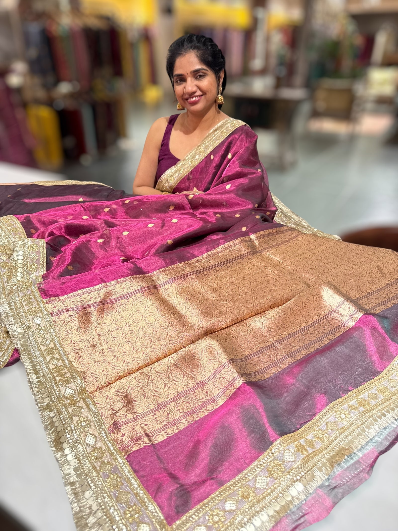 Wine Pure handloom Banarasi Tissue saree hemlined with Sabhyasachi style fringe laces .