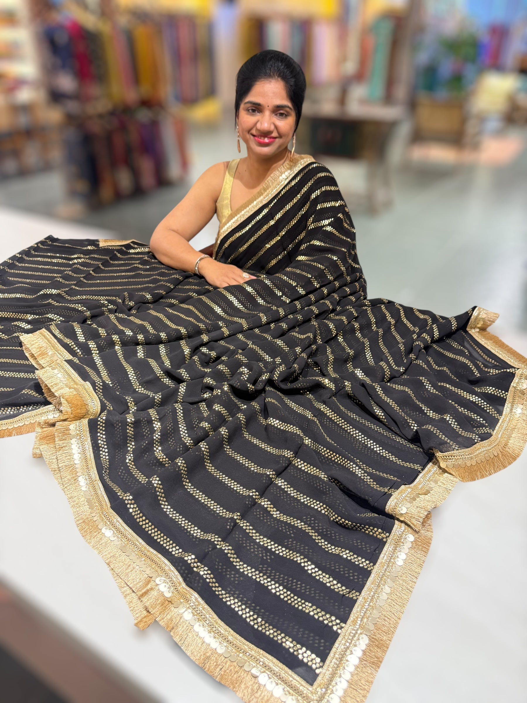 Black Georgette Saree with stick on Badla in stripes pattern and kiran Lace