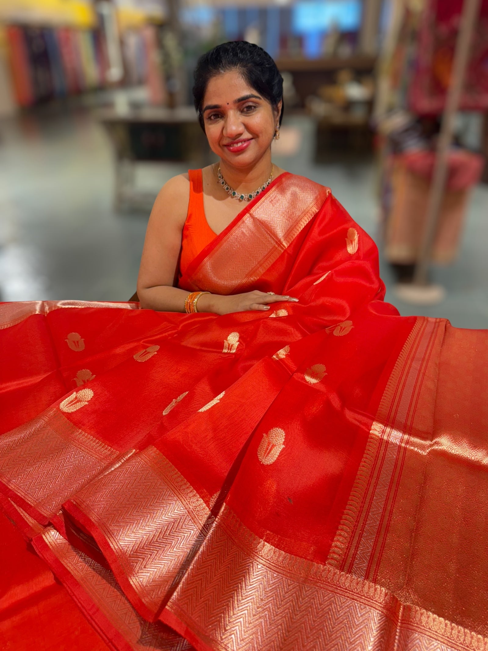 Orangish Red Premium Kora Banarasi Saree with heavy weaving borders and Raw mango style motifs