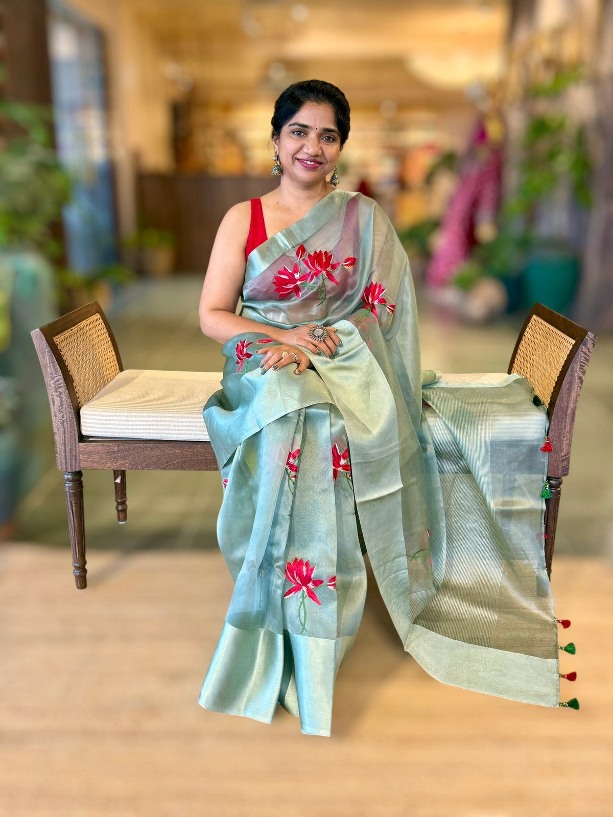 Teal Organza Saree with Lotus flower embroidery and Satin Borders.