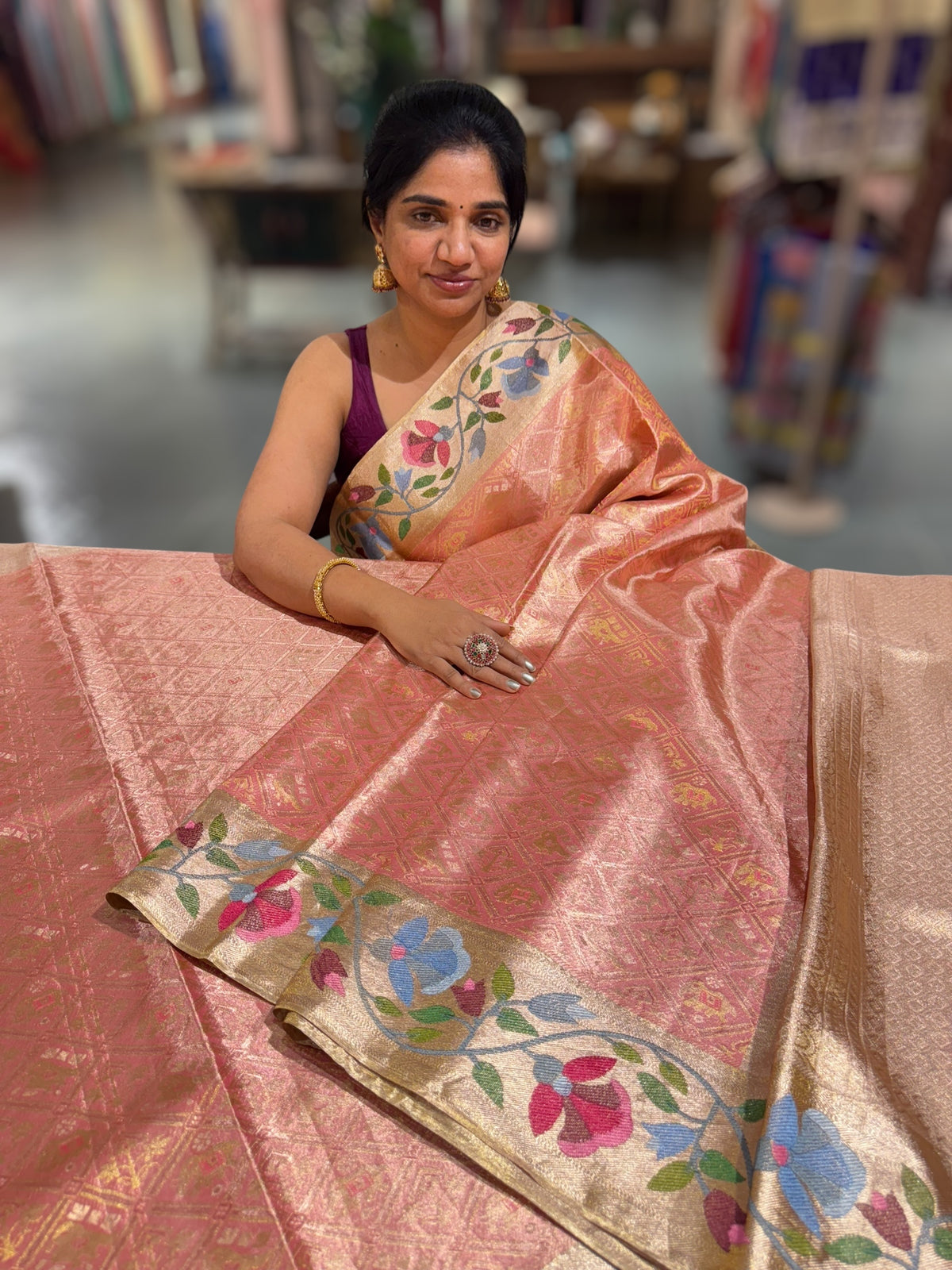 Coral Peach Kanchi Tissue Brocade Saree With jamdani inspired embroidery.