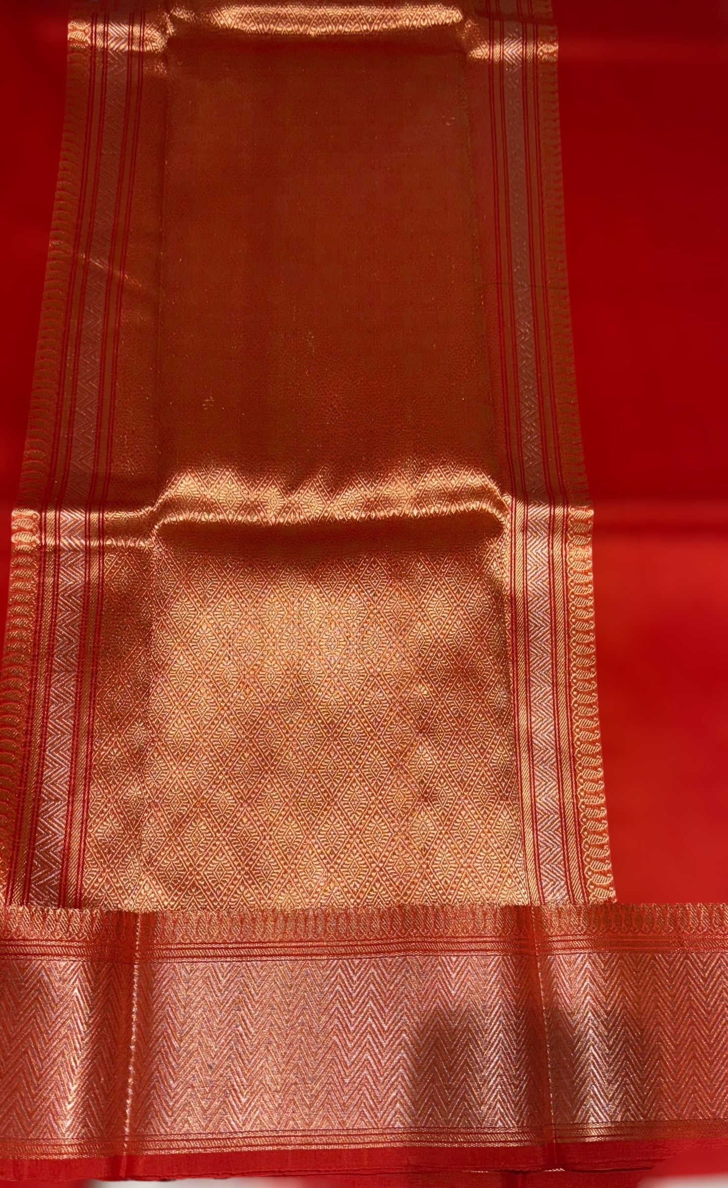 Orangish Red Premium Kora Banarasi Saree with heavy weaving borders and Raw mango style motifs