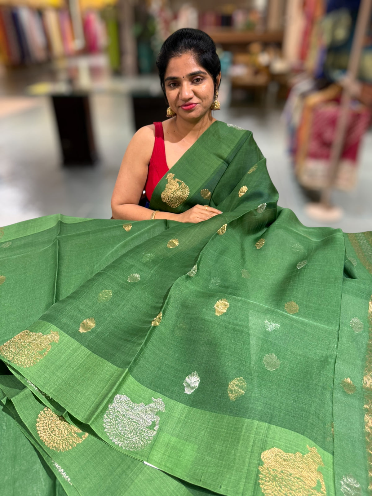 Emerald Green kora muslin sarees with kaduwa woven nandi motif border